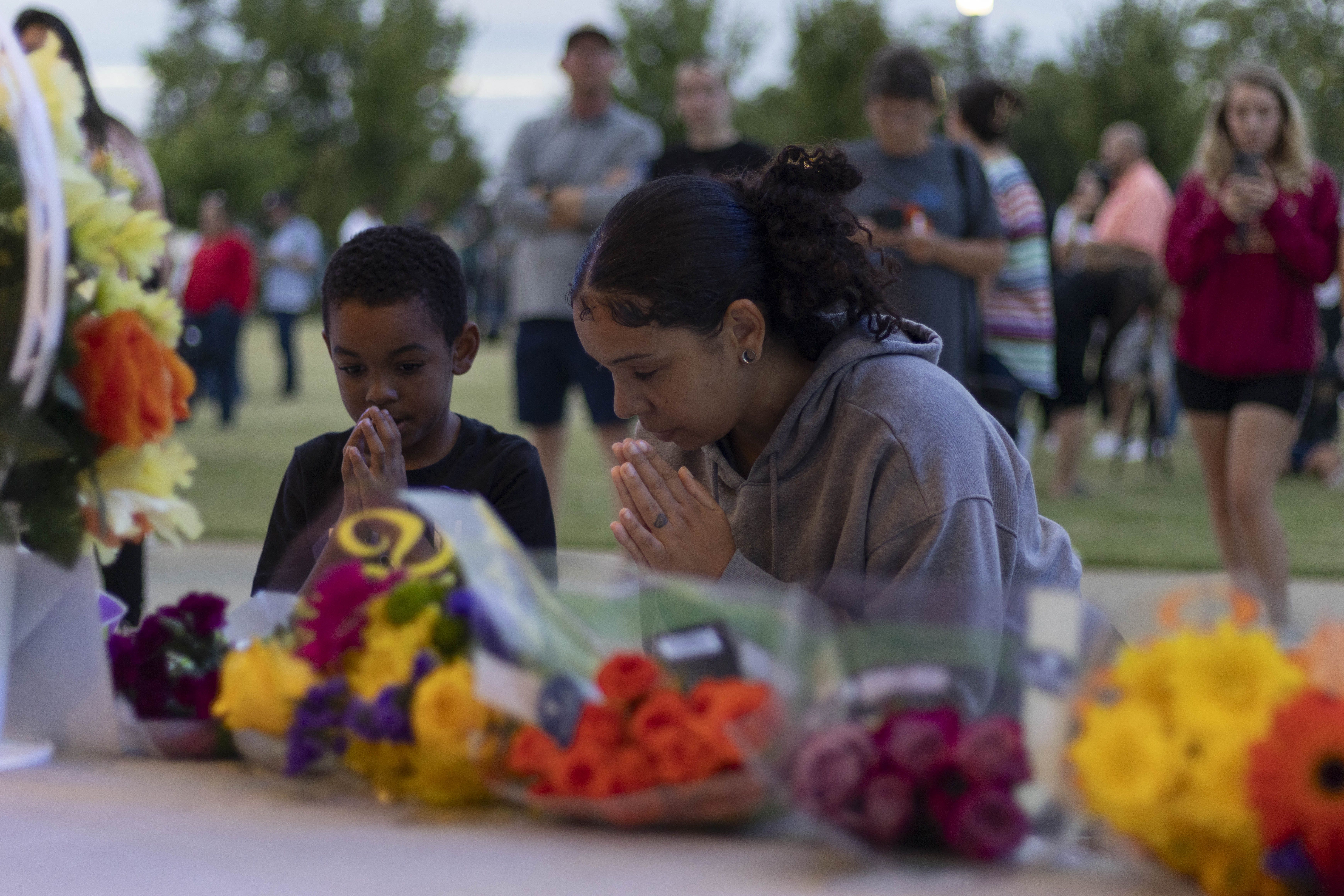 People pray during a vigil for the Apalachee High School shooting at Jug Tavern Park in Winder, Georgia, on September 4, 2024.