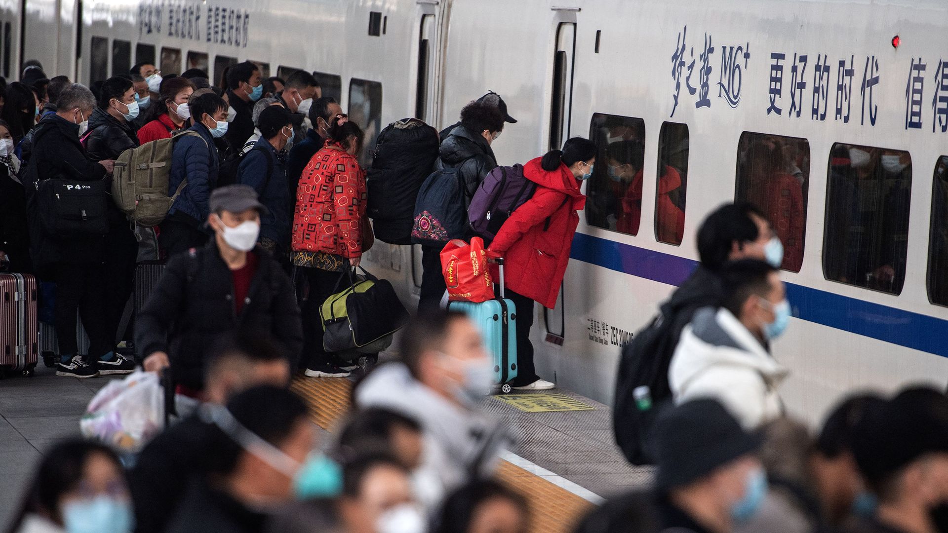  passengers preparing to board their train at Hankou railway station on the first day of peak travel ahead of the Lunar New Year of the Rabbit in Wuhan, in China's central Hubei province. 
