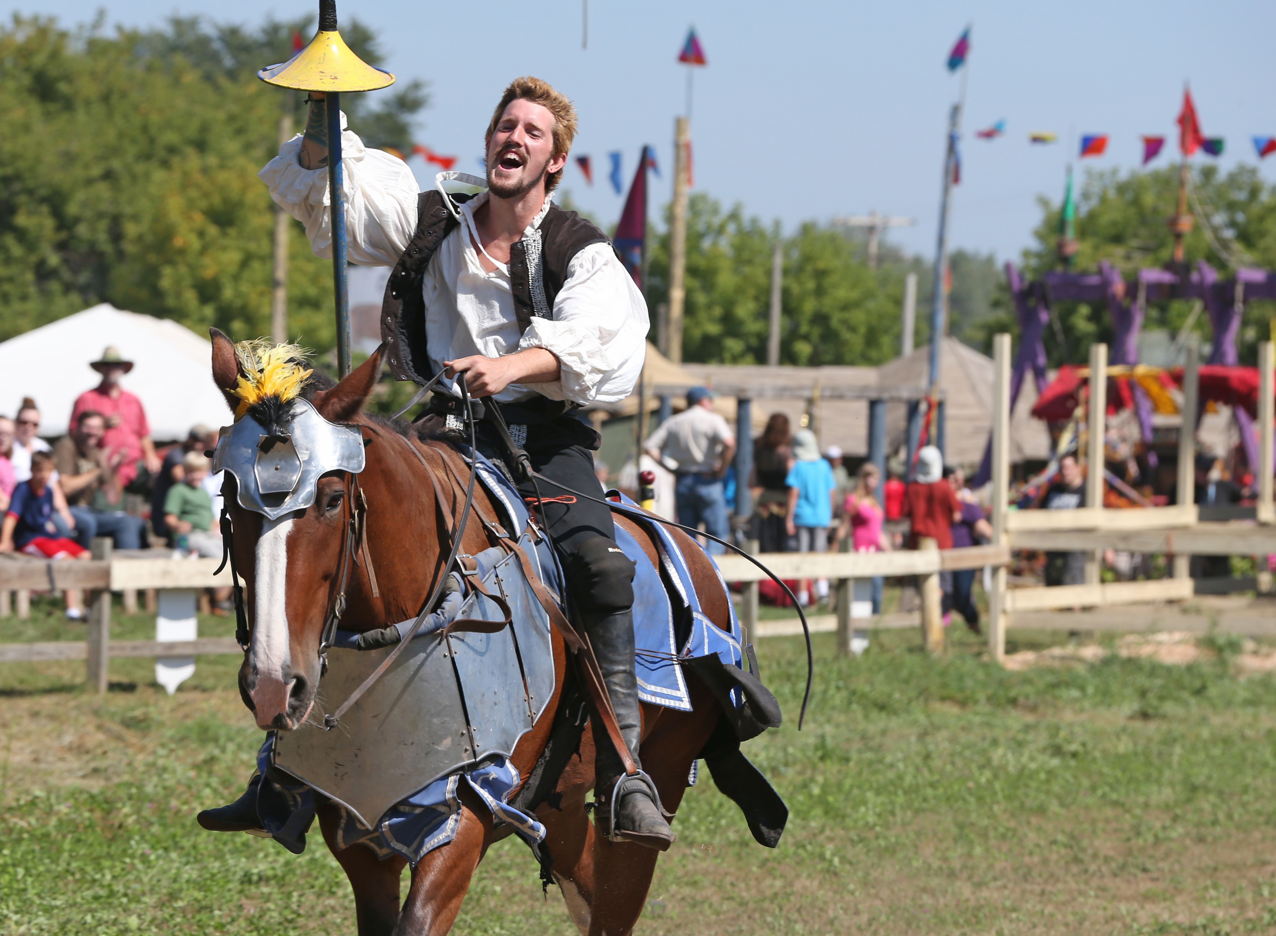 A man demonstrates jousting in renaissance clothing.