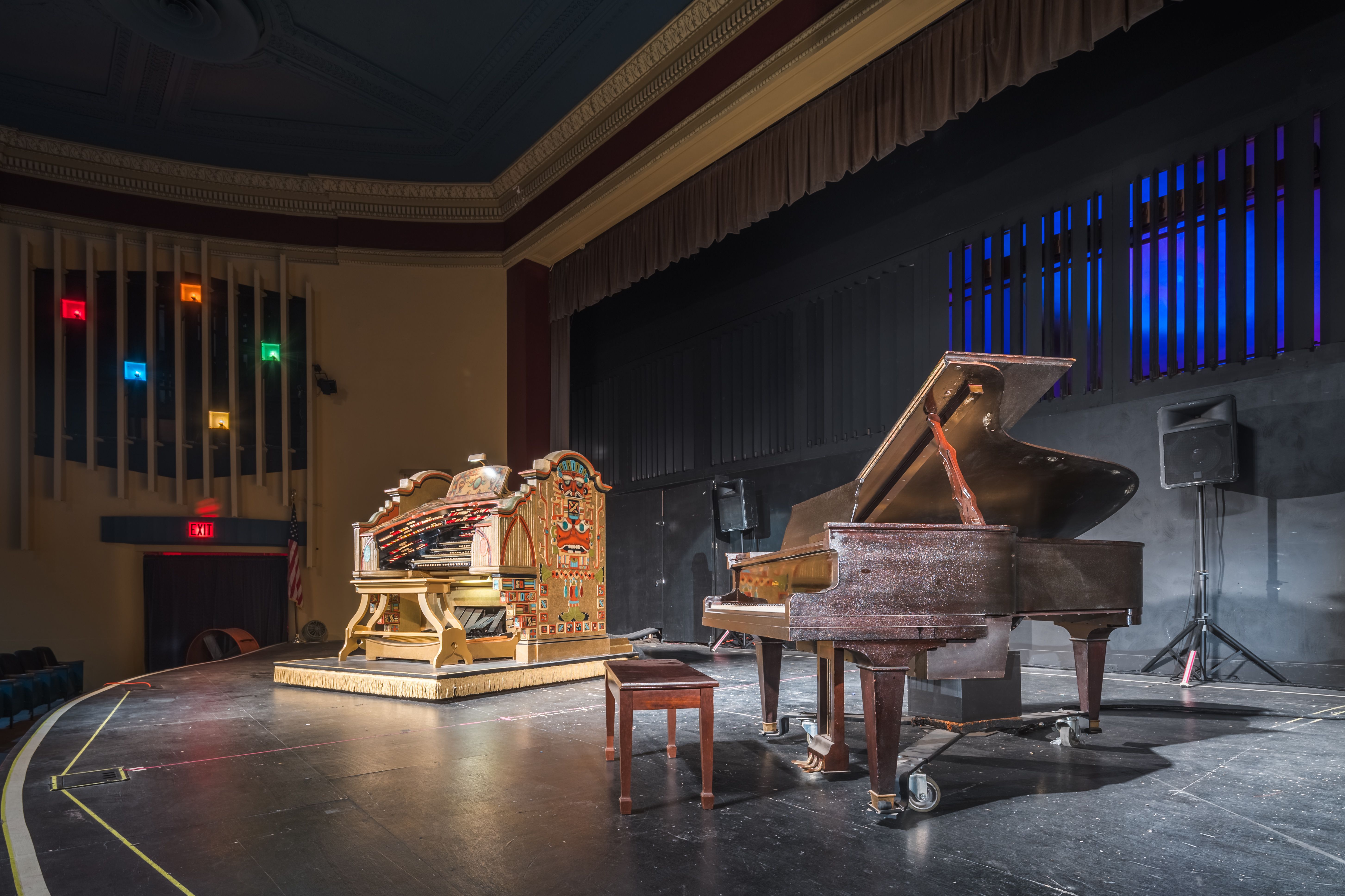 The organ stands on stage next to a piano