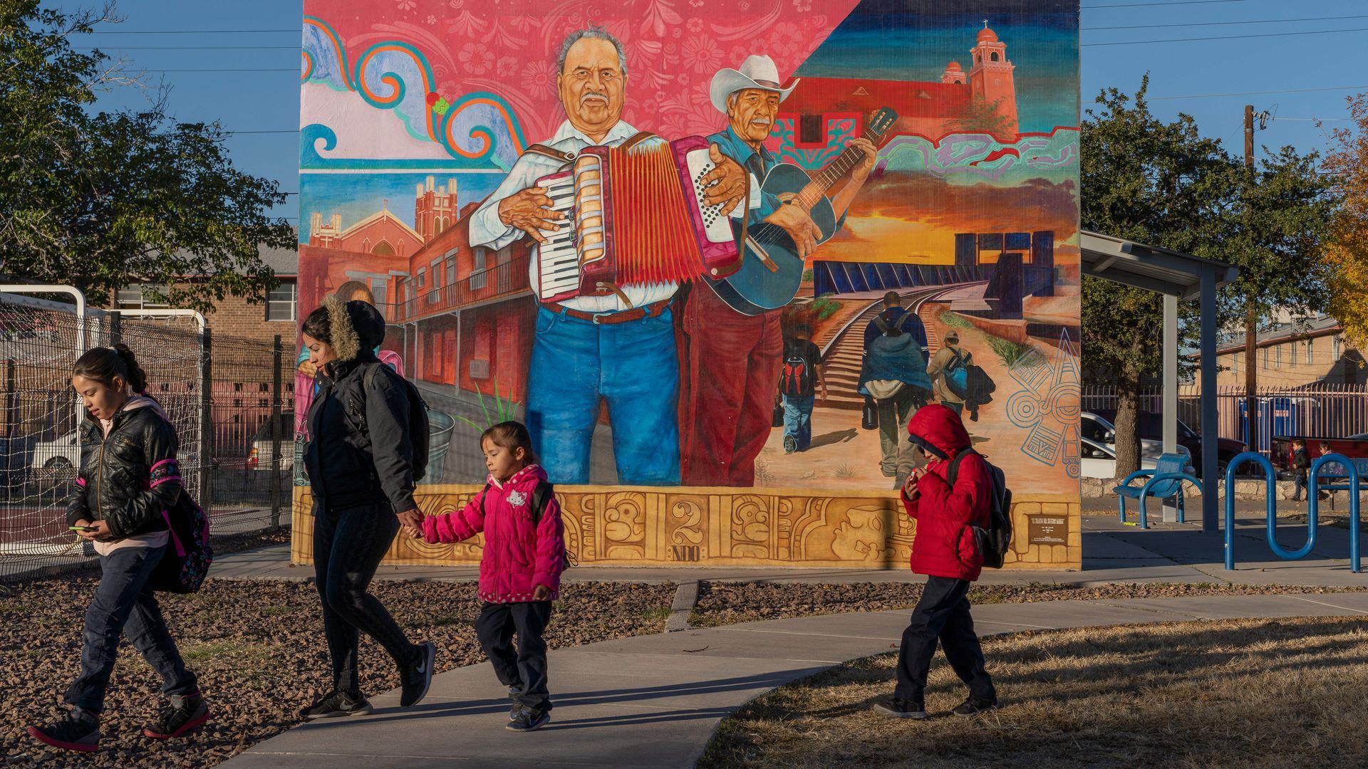 Mexican American residents walk by a mural in El Paso, Texas. Photo: Paul Ratje/AFP via Getty Images