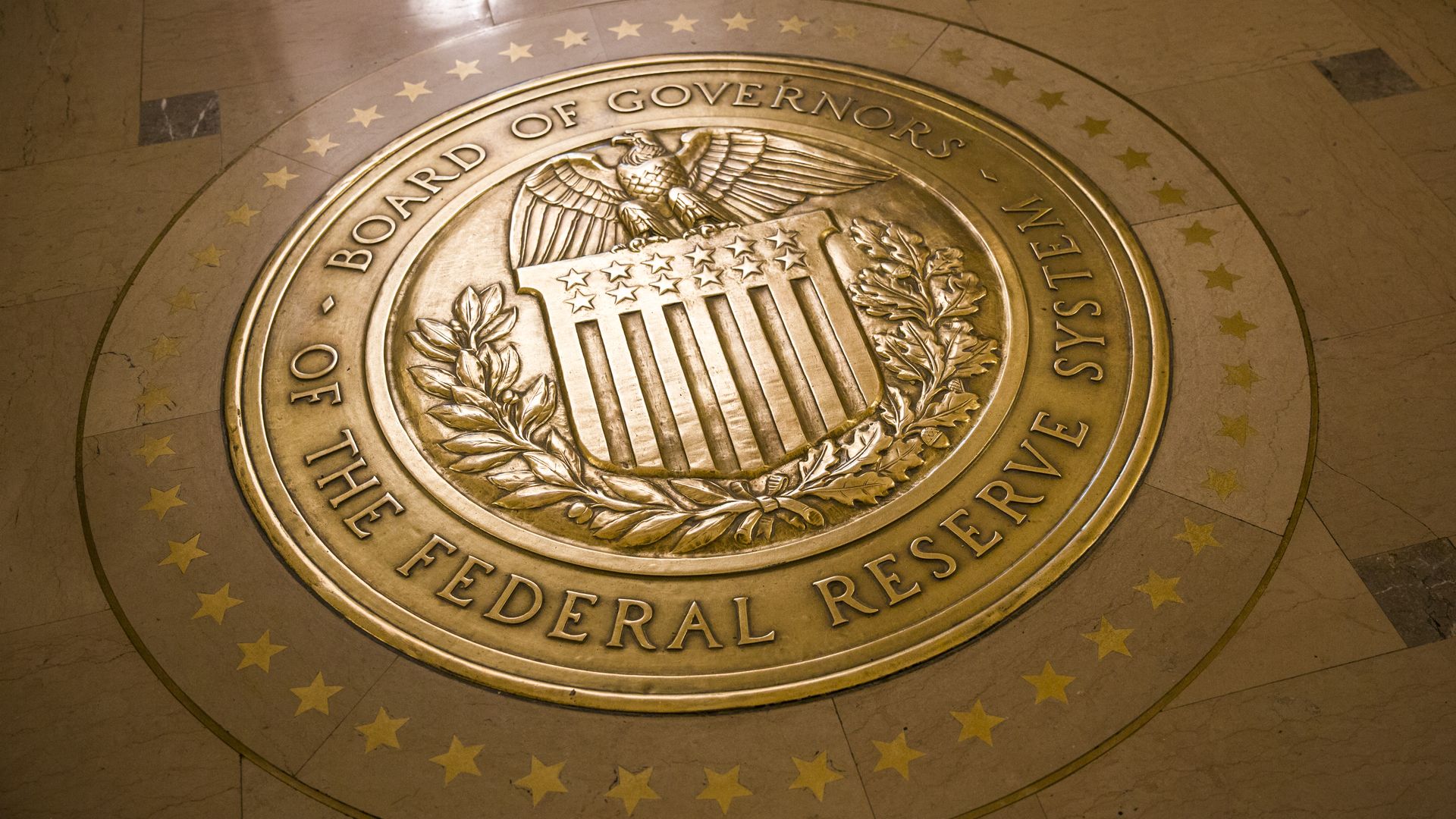 A gold plated seal outside inside the Eccles Building, the place of the Board of Governors of the Federal Reserve System