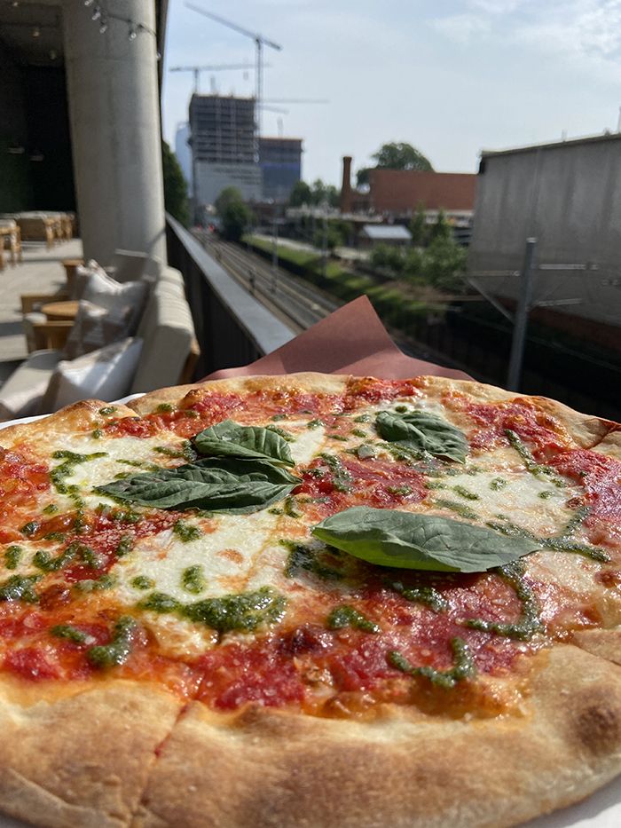 Sycamore's cheese pizza ($13) overlooking the rail trail. Photo: Ashley Mahoney/Axios