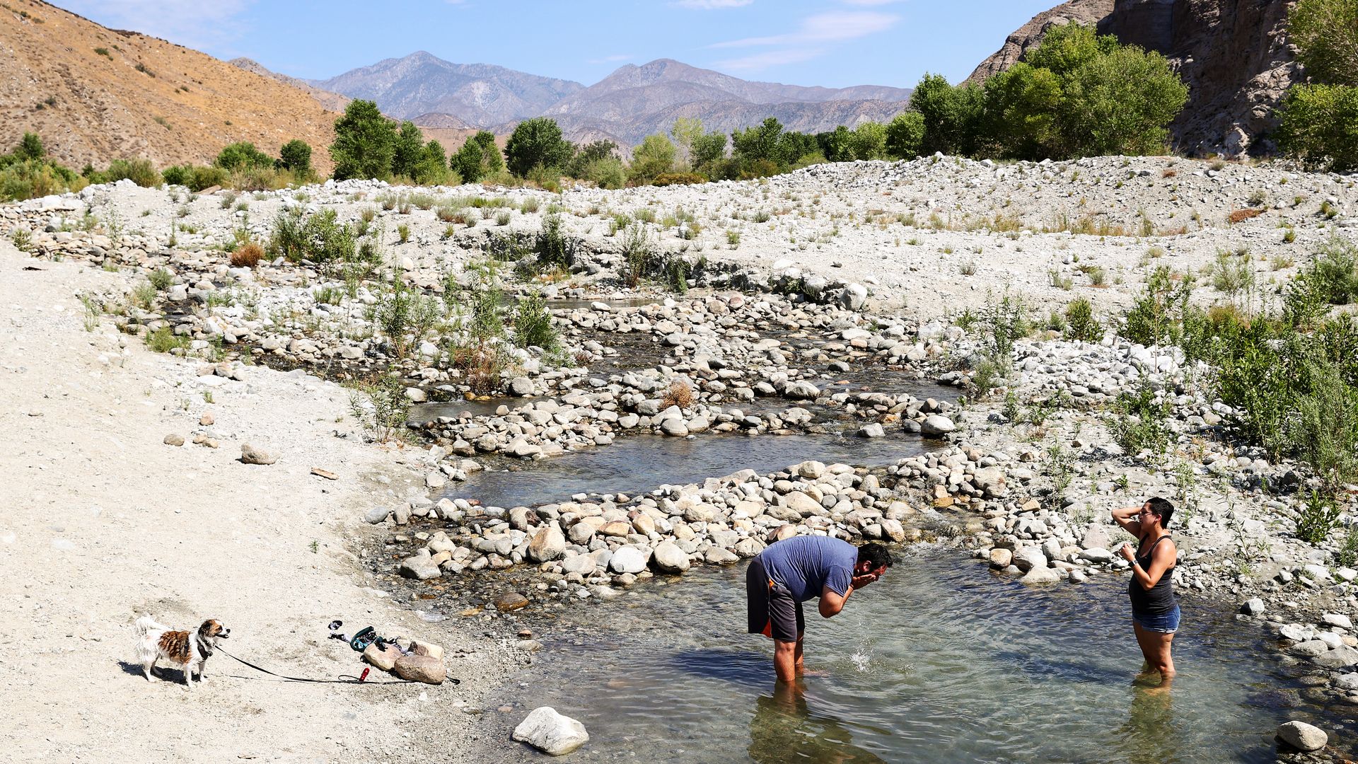 People cool off in the Whitewater River in Whitewater, California.