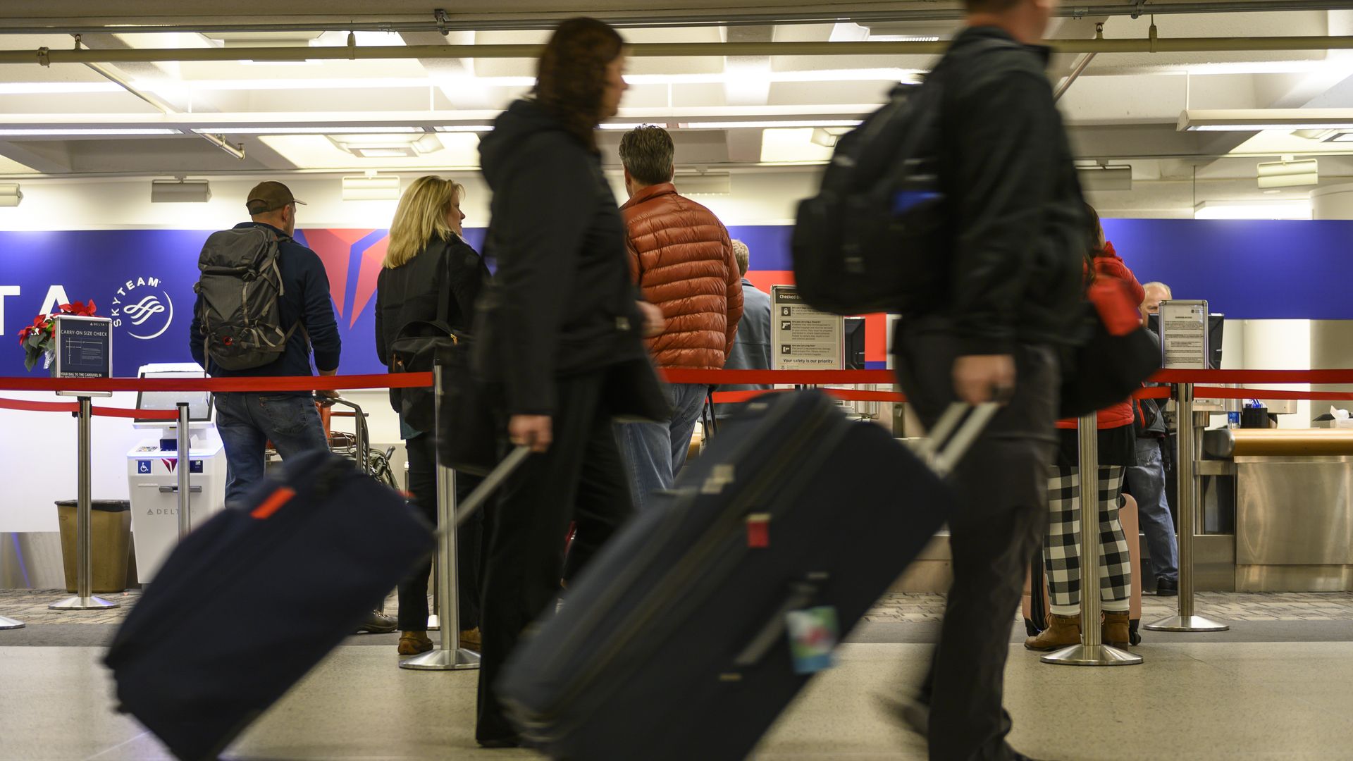Travelers pass through Minneapolis-St. Paul International Airport.