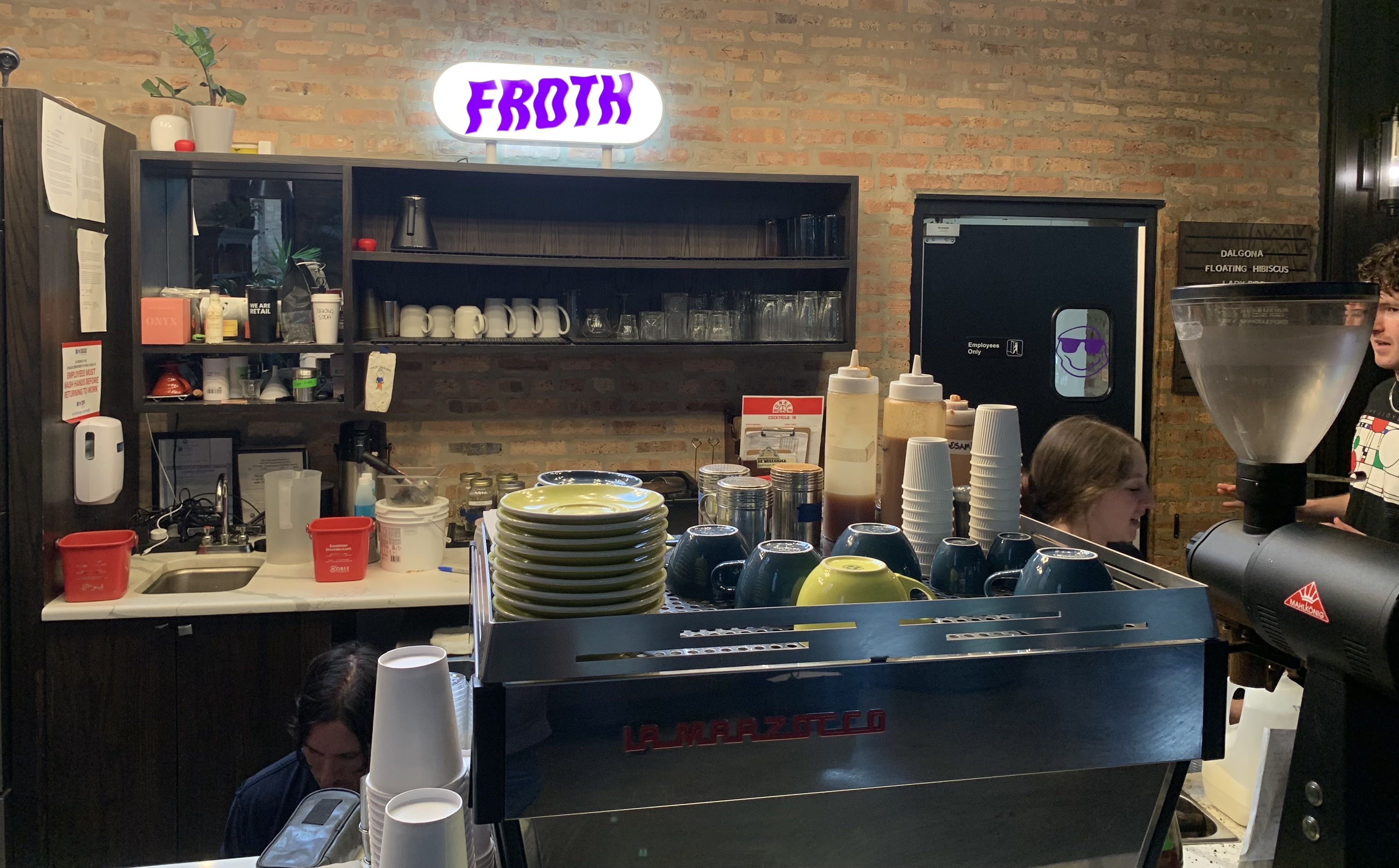 Photo of a sign that says "Froth" and a coffee bar. 