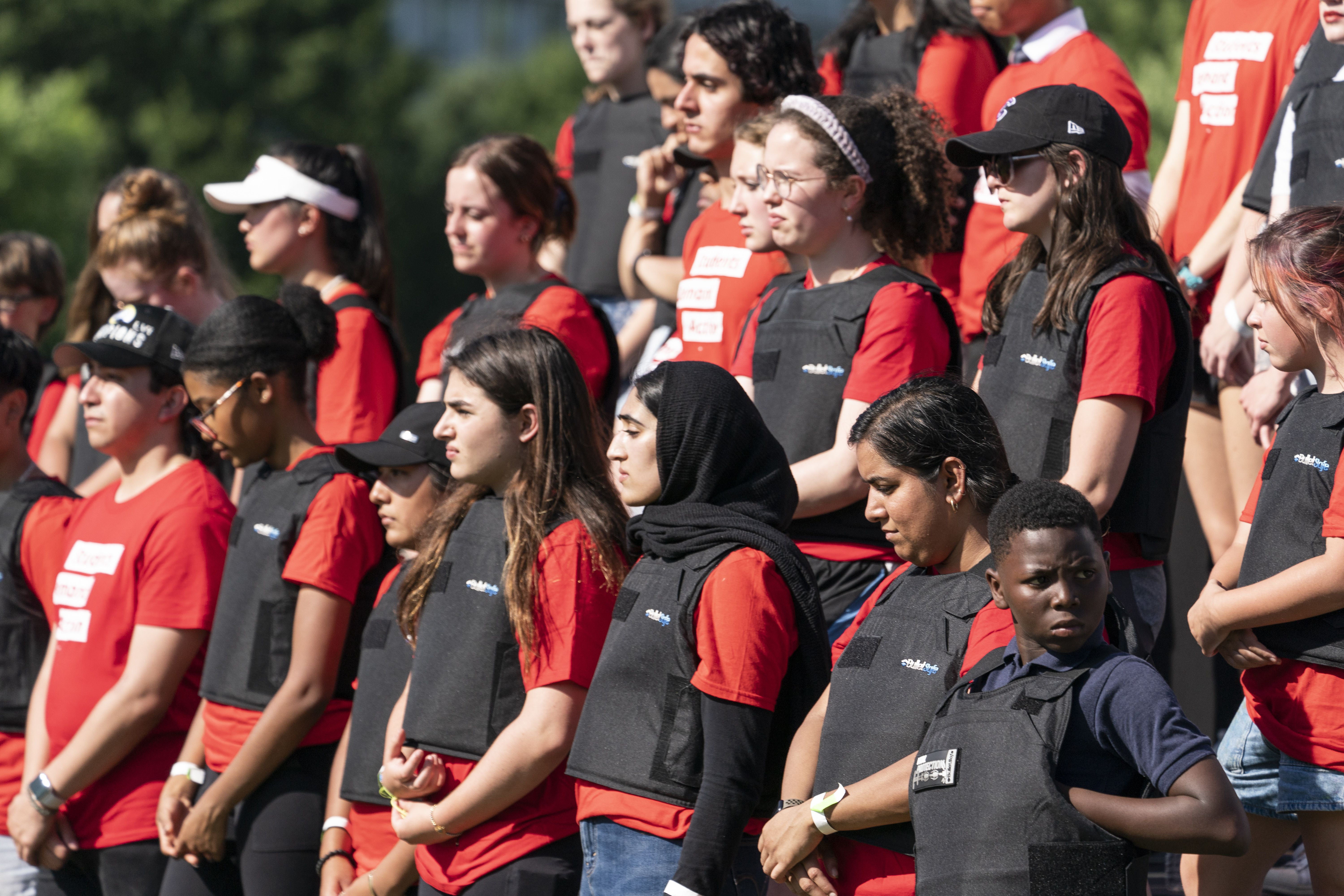 Student activists wear body armor in front of the Capitol