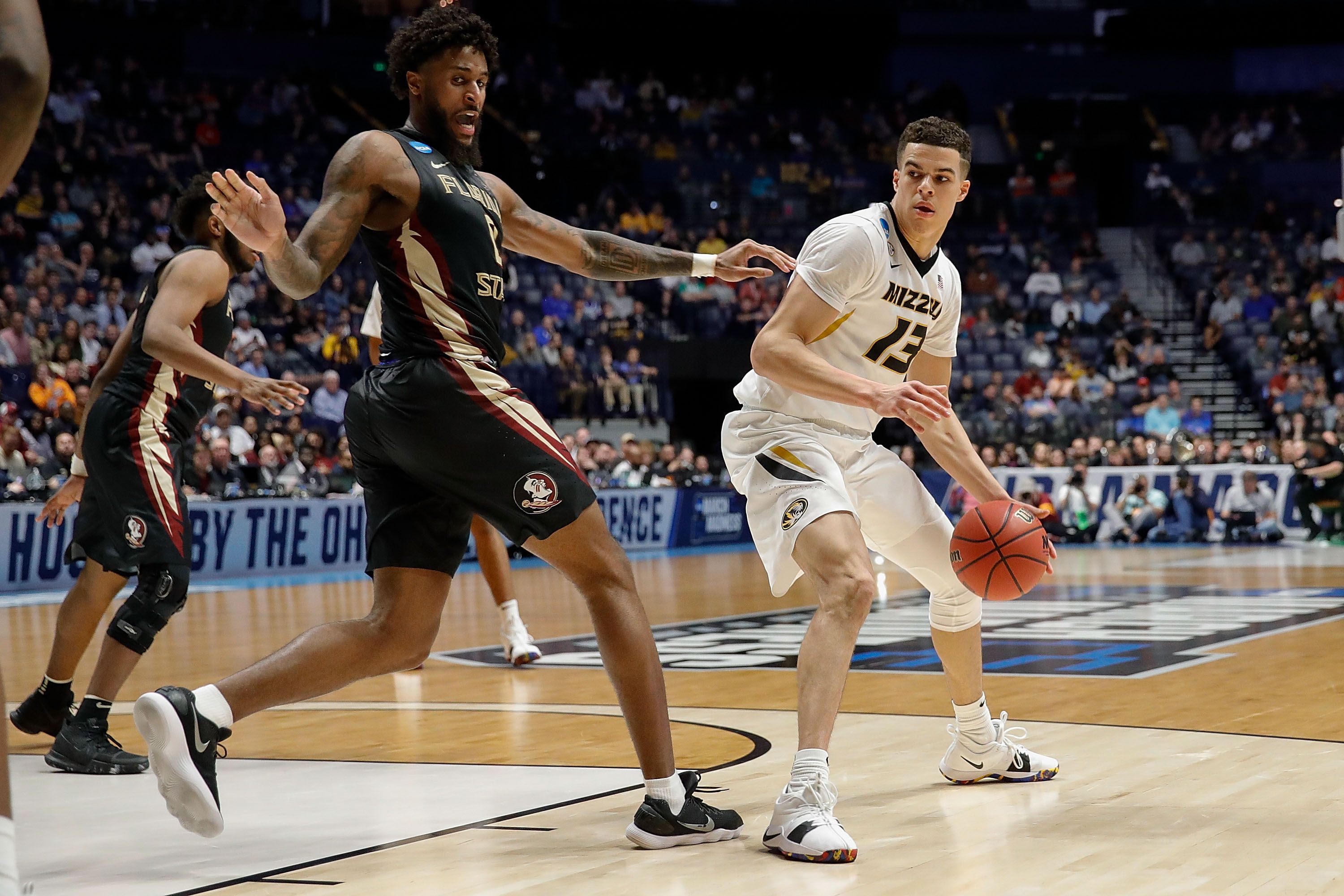 A man holds a basketball.