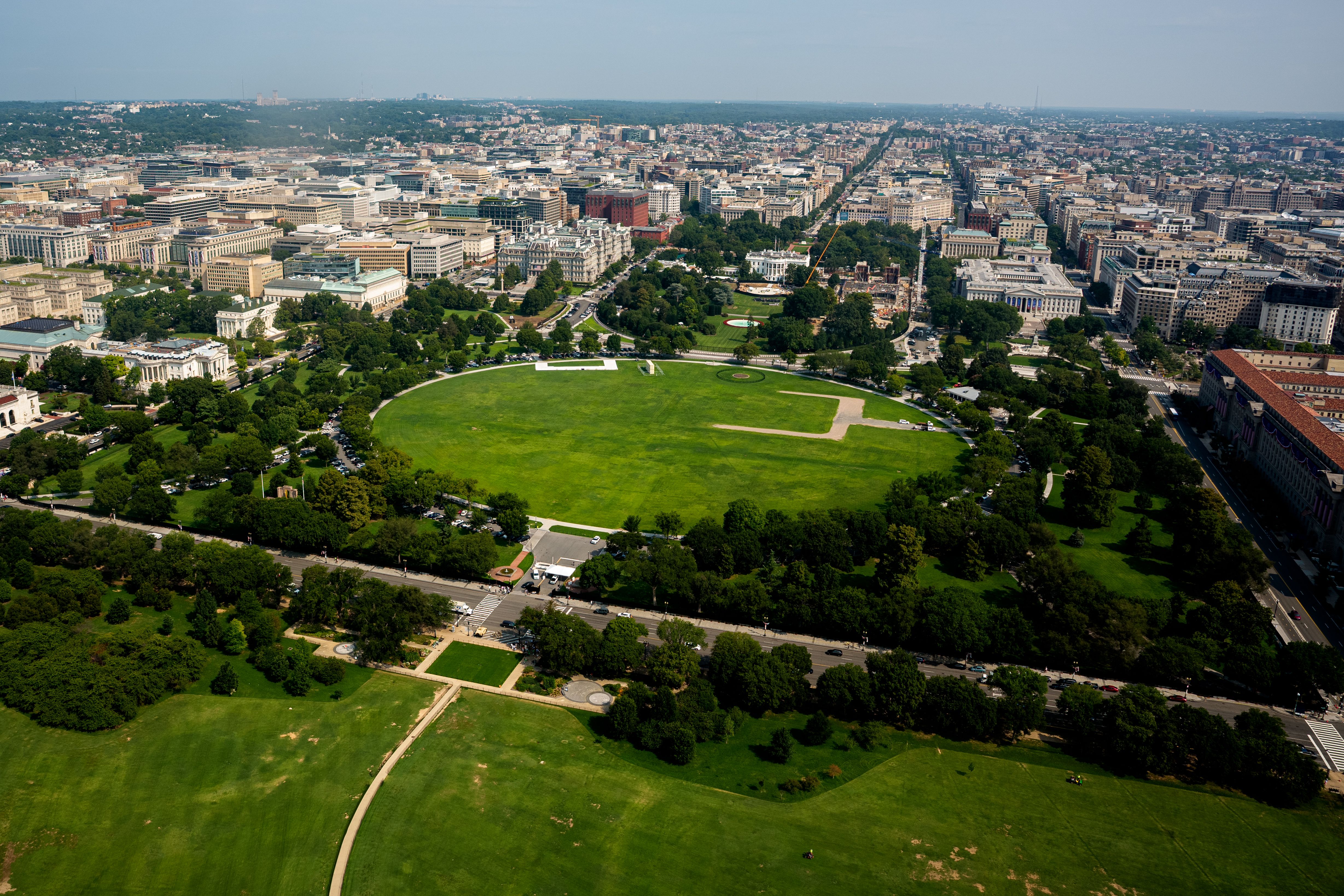 Construction equipment and materials surround the White House as work continues near the East Wing ballroom site and on a new South Lawn helipad.