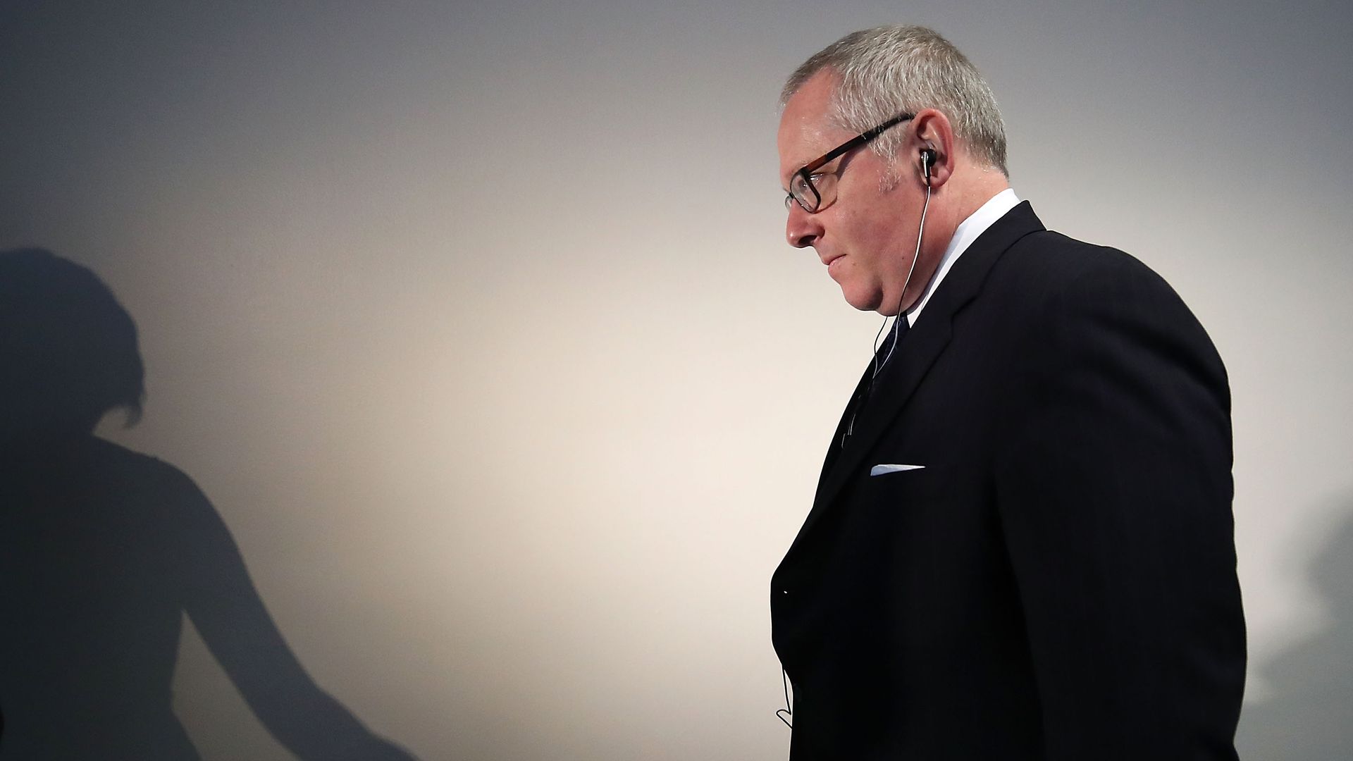 Michael walks down a hallway