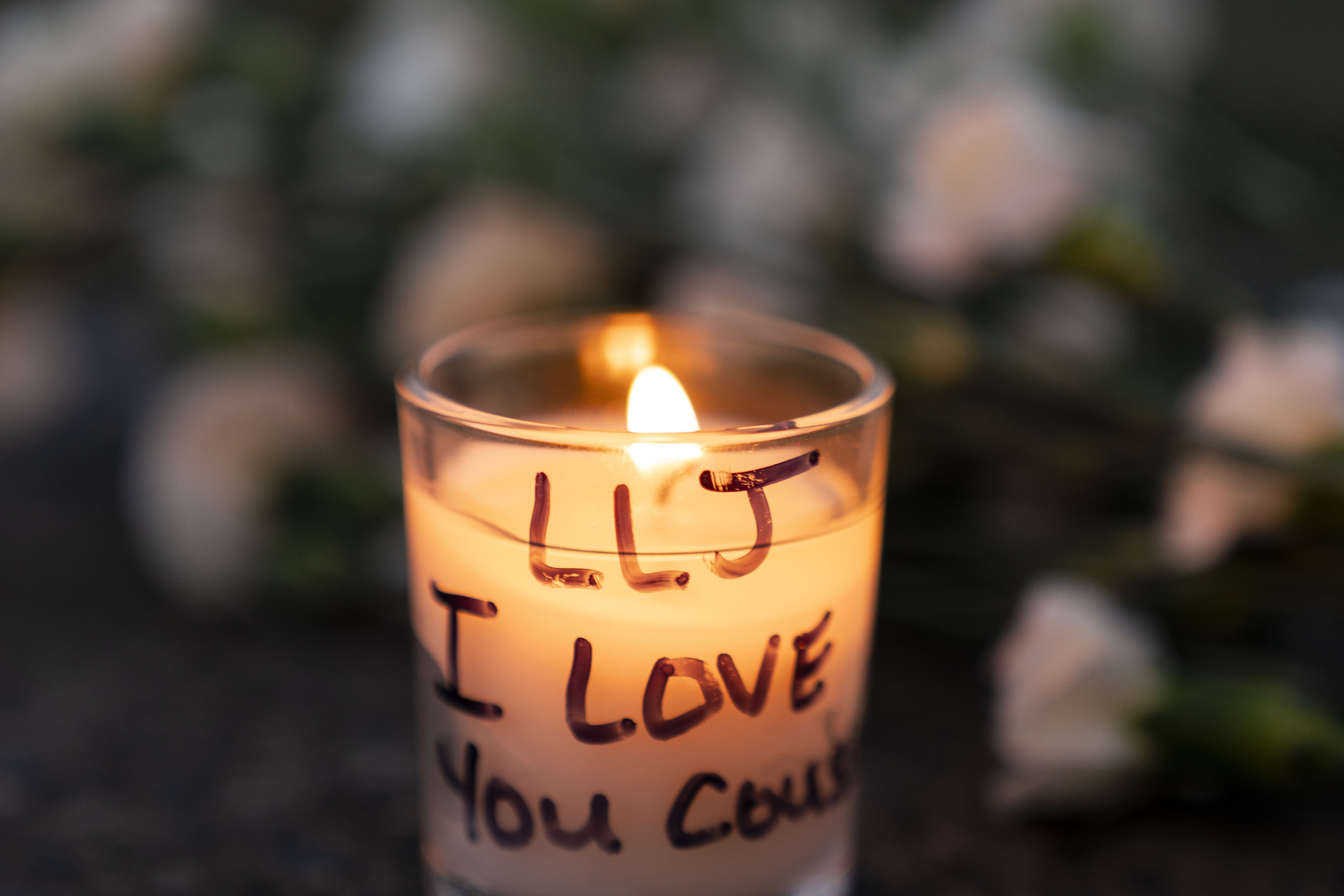 A candle with the words "LLJ I love you."