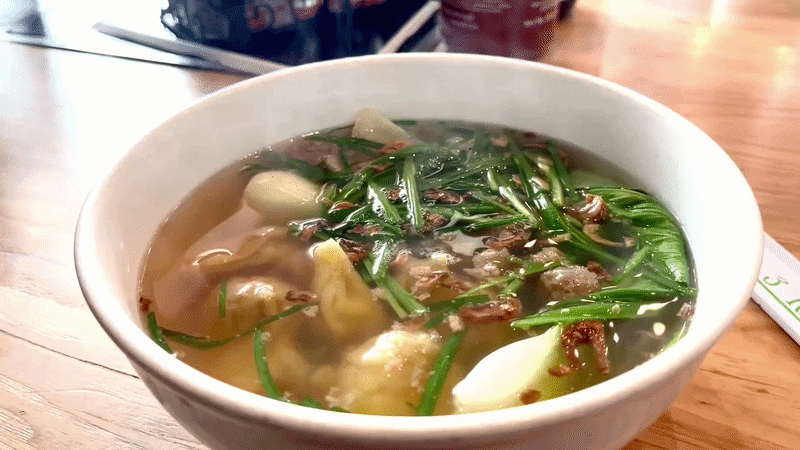 A gif showing a steaming bowl of wonton soup