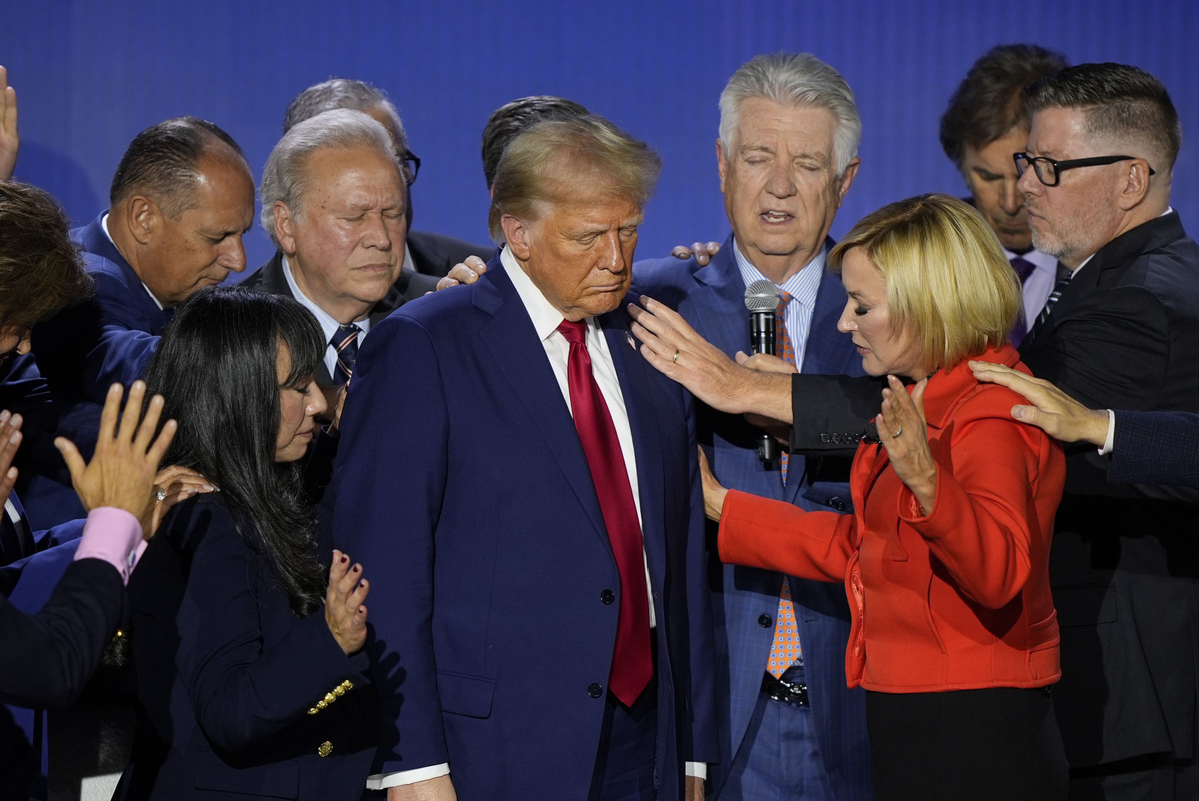 Pastor Paula White prays over former President Trump during the National Faith Summit yesterday in Powder Springs, Ga.