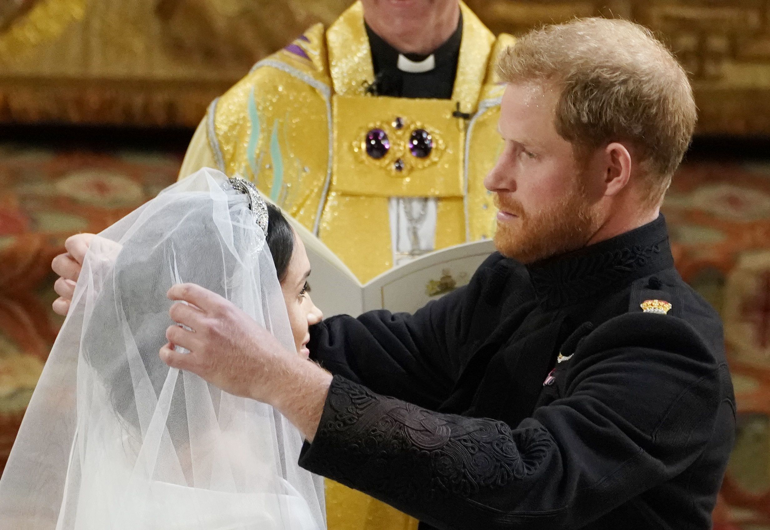 Prince Harry lifts Meghan Markle's veil.