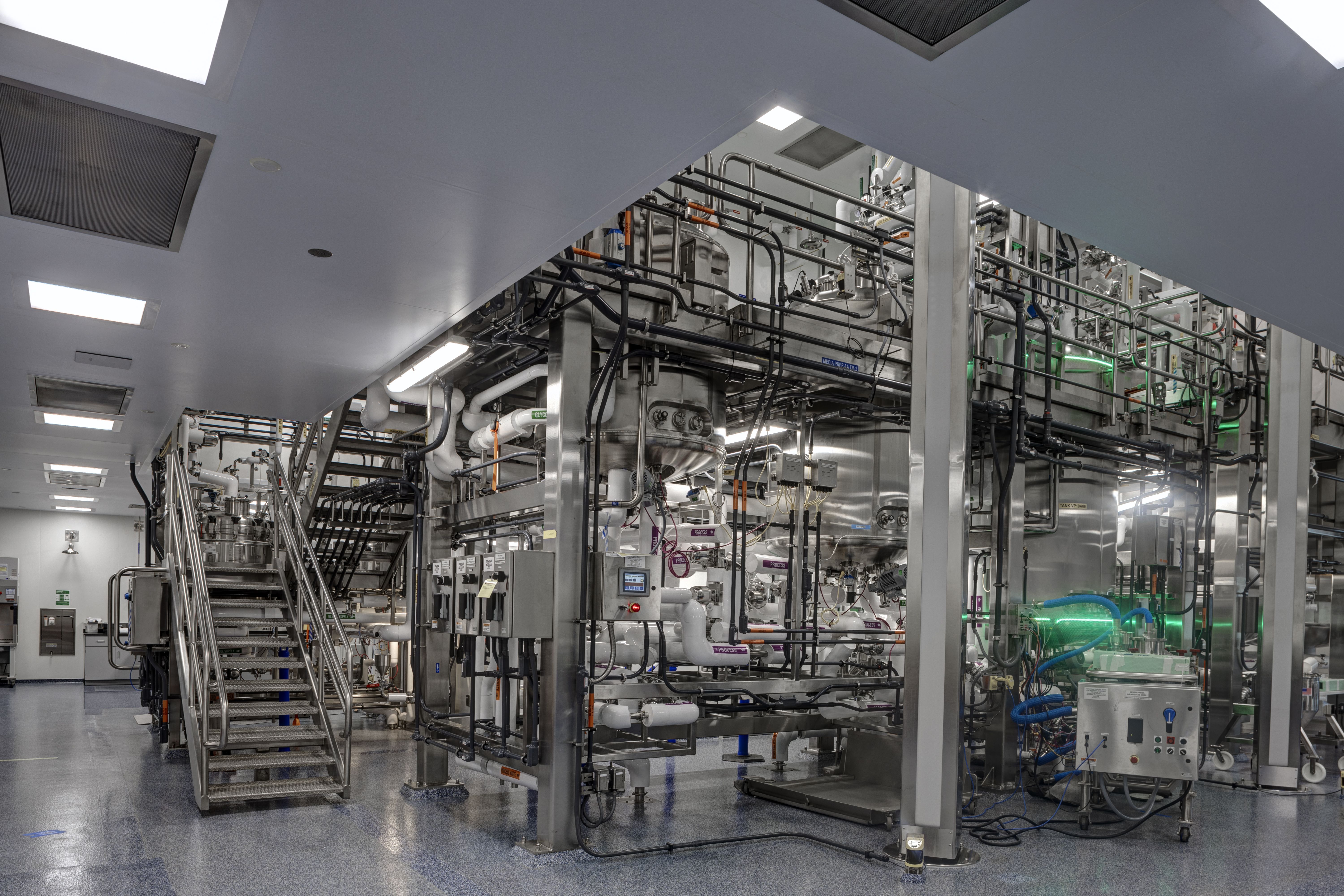 A complicated network of pipes and machines inside an industrial lab.