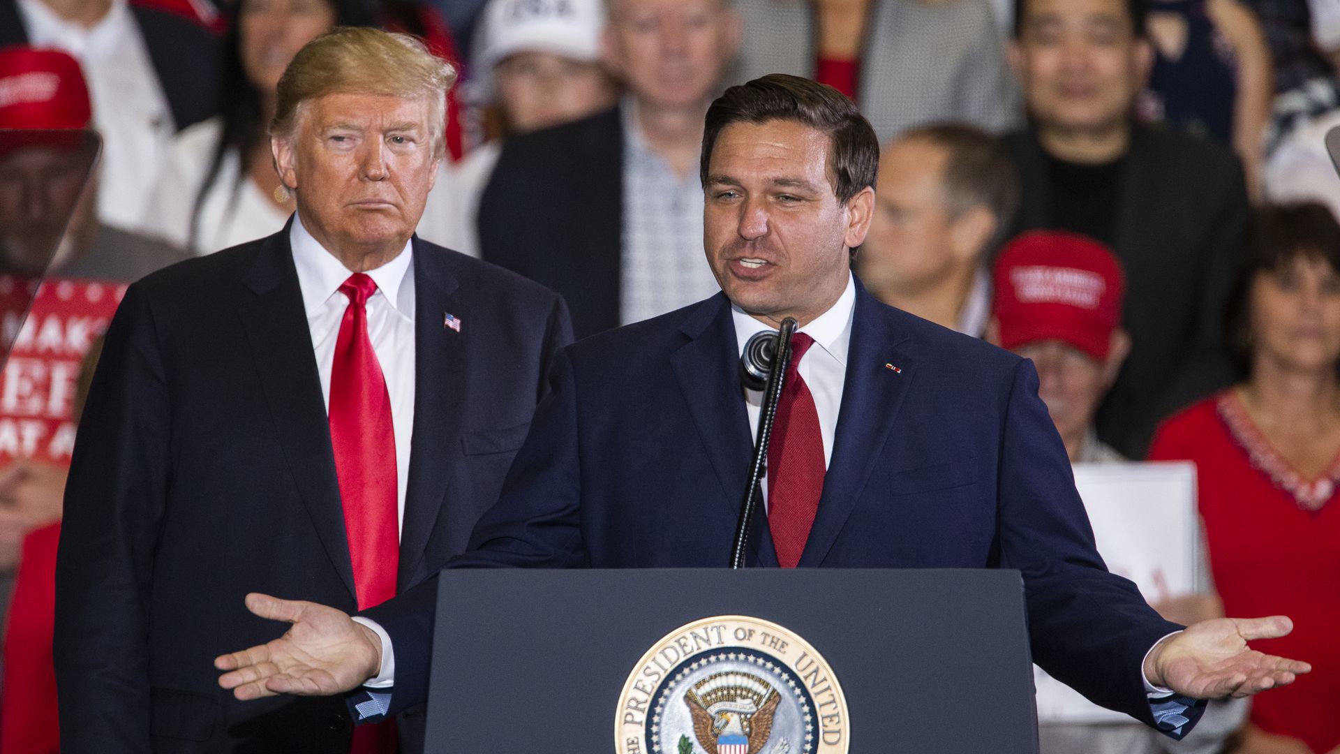 Florida Republican gubernatorial candidate Ron DeSantis speaks with U.S. President Donald Trump at a campaign rally at the Pensacola International Airport on November 3, 2018 in Pensacola, Florida