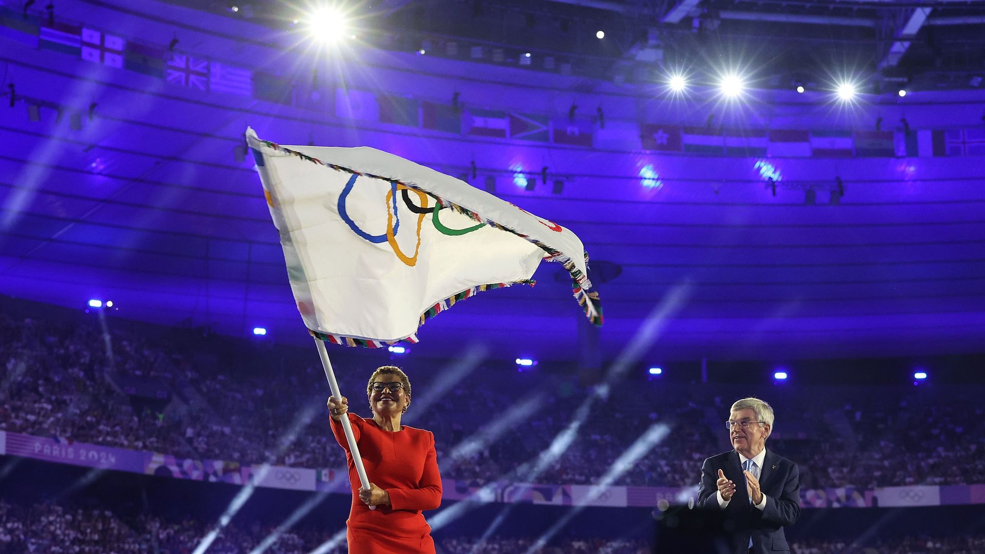 LA Mayor Karen Bass waves the Olympic flag at the Paris 2024 closing ceremony.