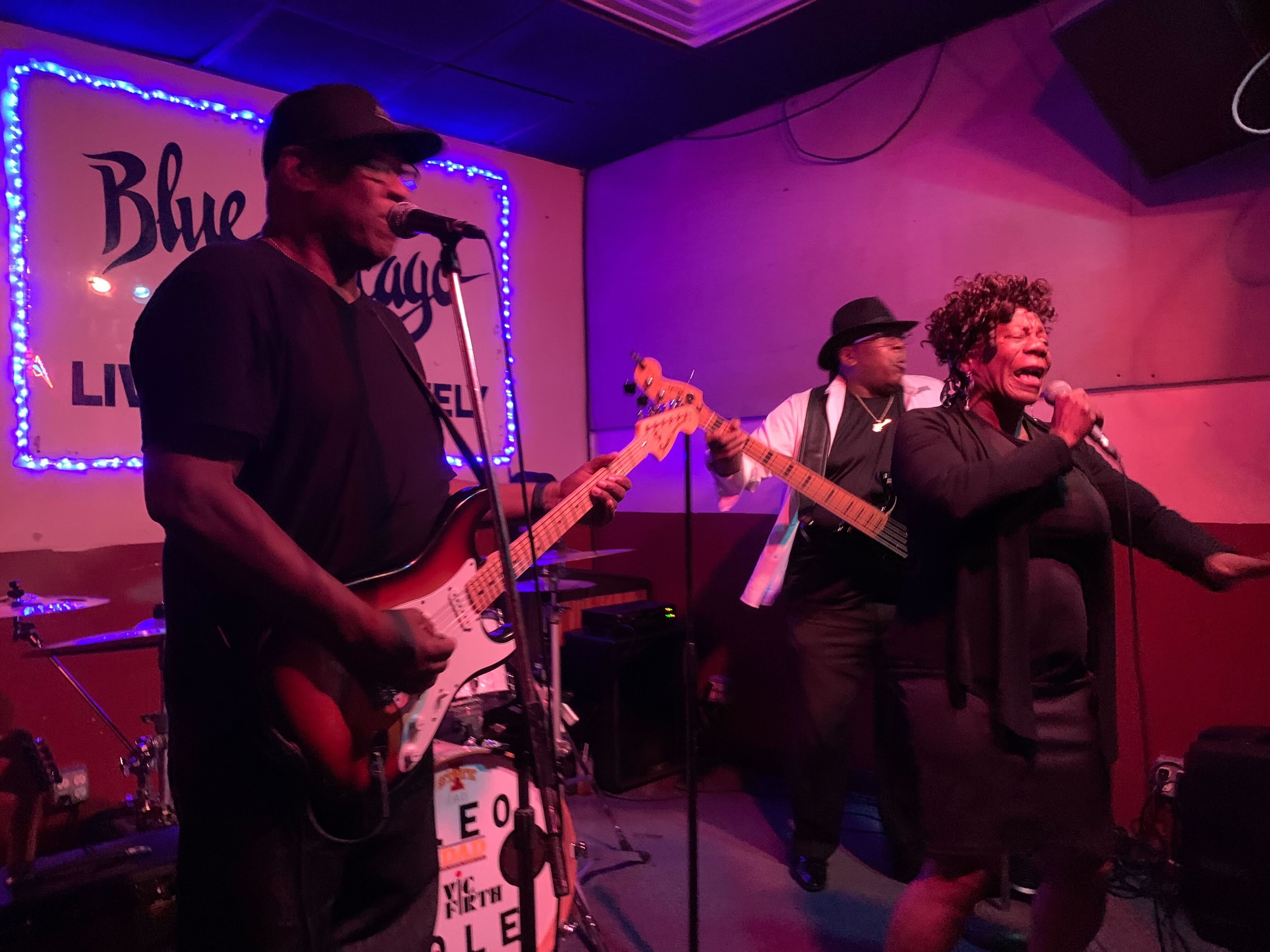 Photo of a band playing music on a stage 
