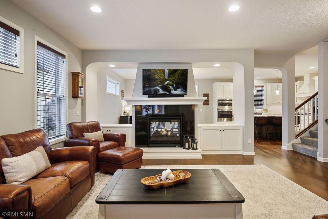 living room with see-through fire place that looks into dining room
