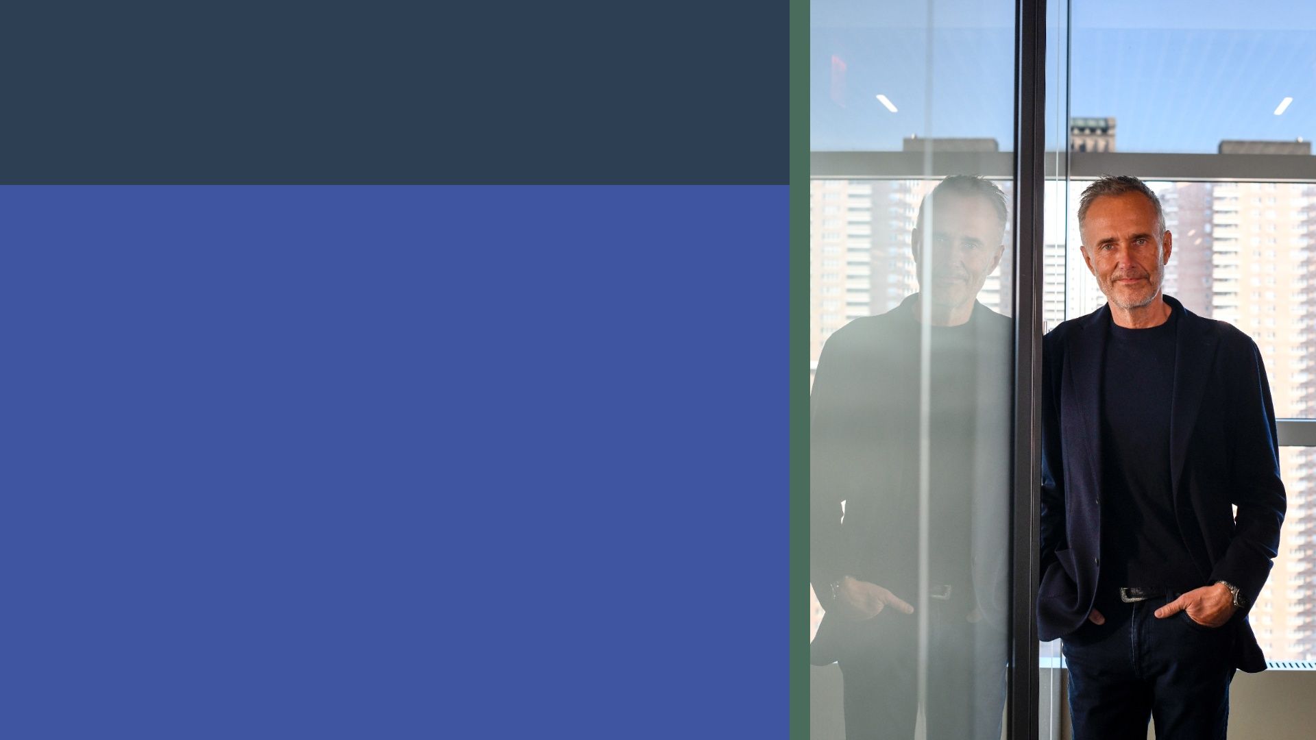 Middle-aged man in a dark blazer stands by a glass wall in a modern office; city buildings visible outside. Left half shows dark blue blocks separated by an olive-green divider.