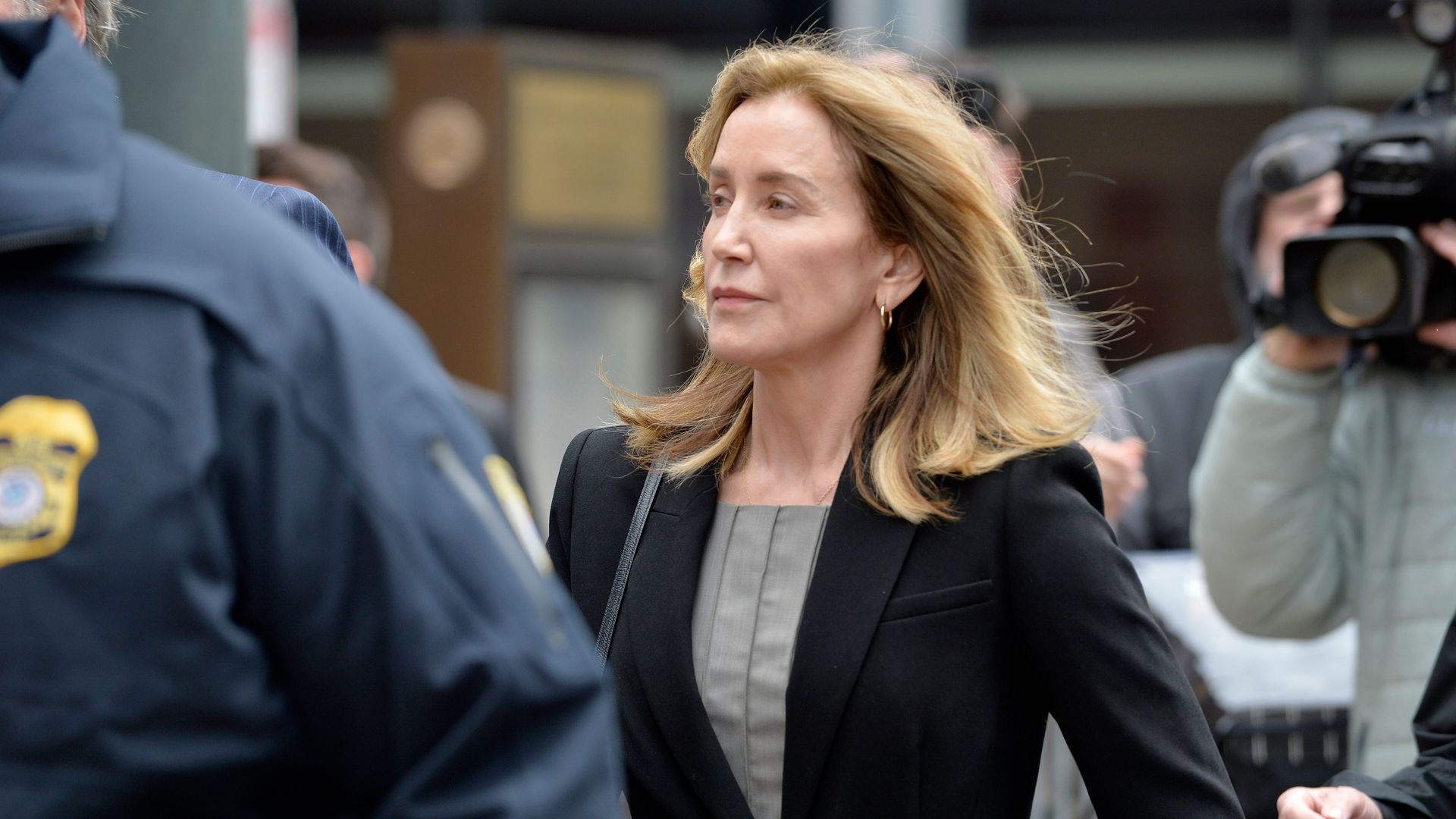 Actress Felicity Huffman is escorted by Police into court on May 13, 2019 in Boston, Massachusetts.