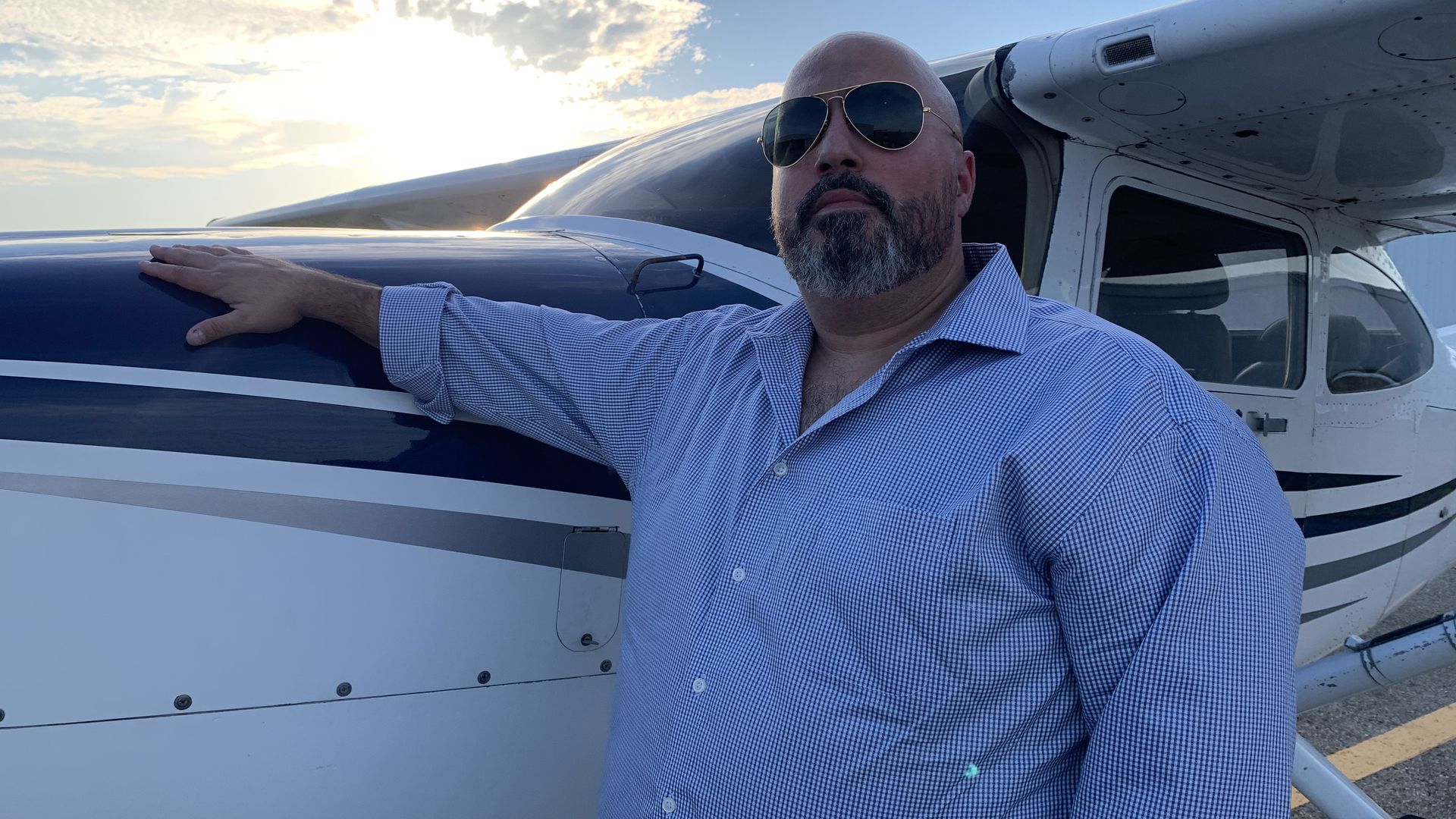 Chris Vasilakis in front of a propeller plane