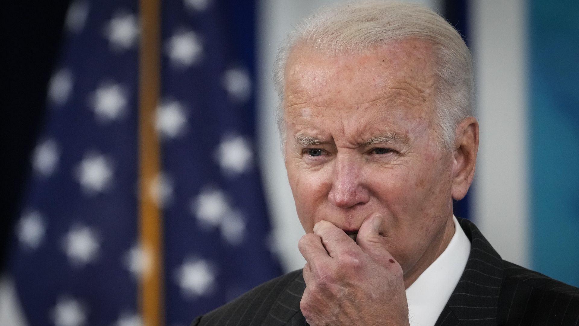 Photo of Joe Biden holding his hand to his mouth
