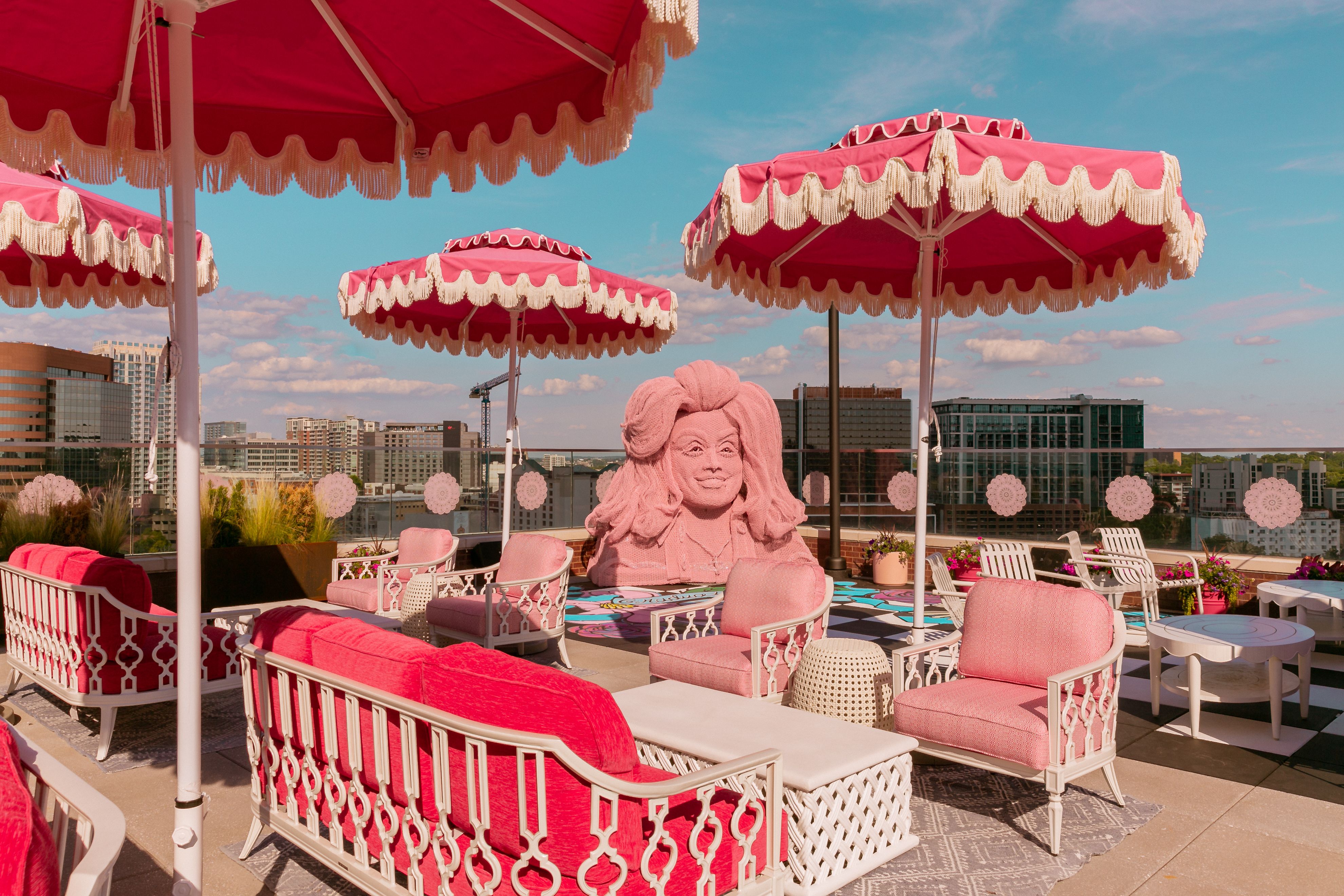 A pink bust of Dolly Parton on a rooftop