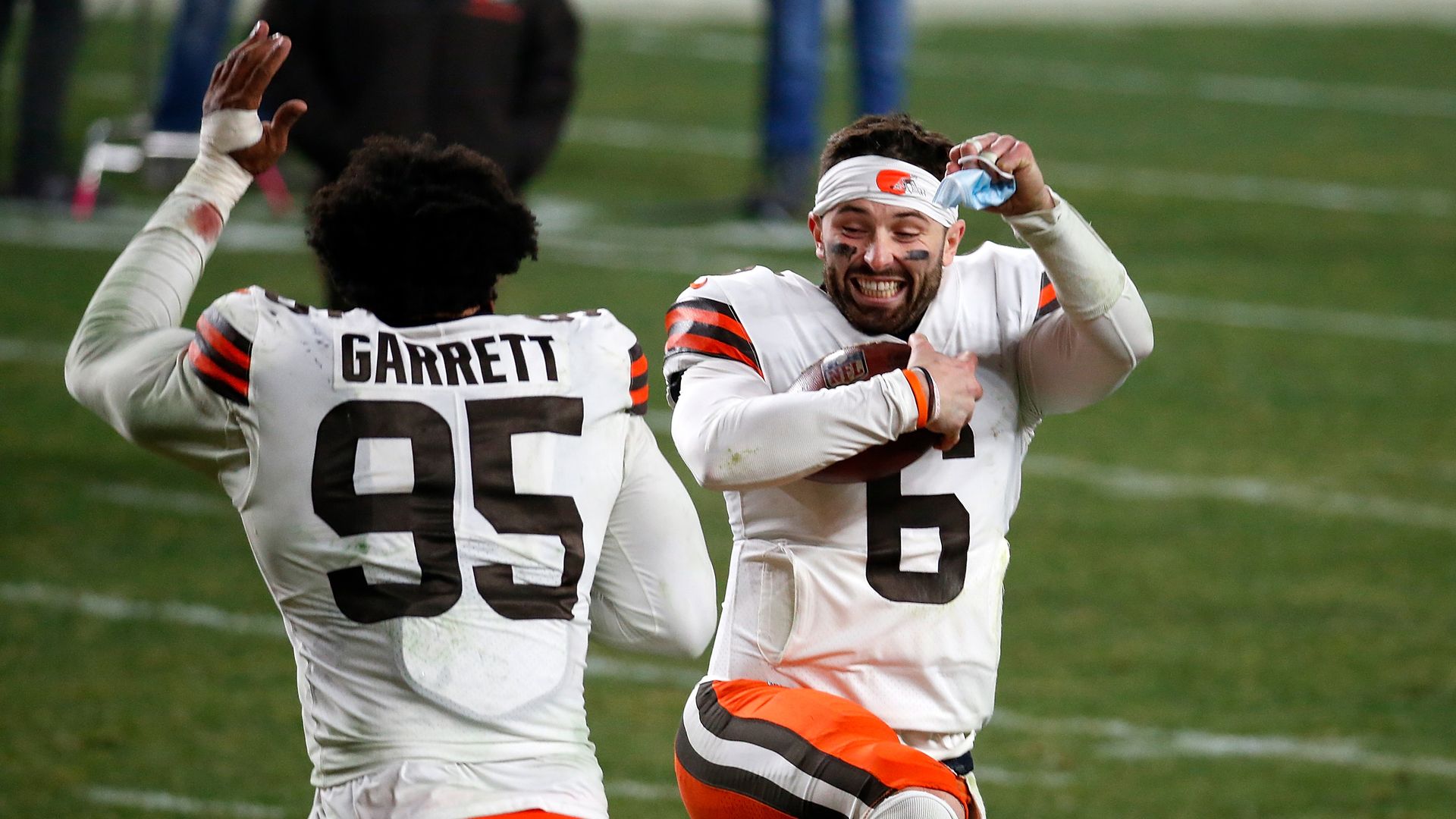 Two Cleveland browns players jump for joy. 