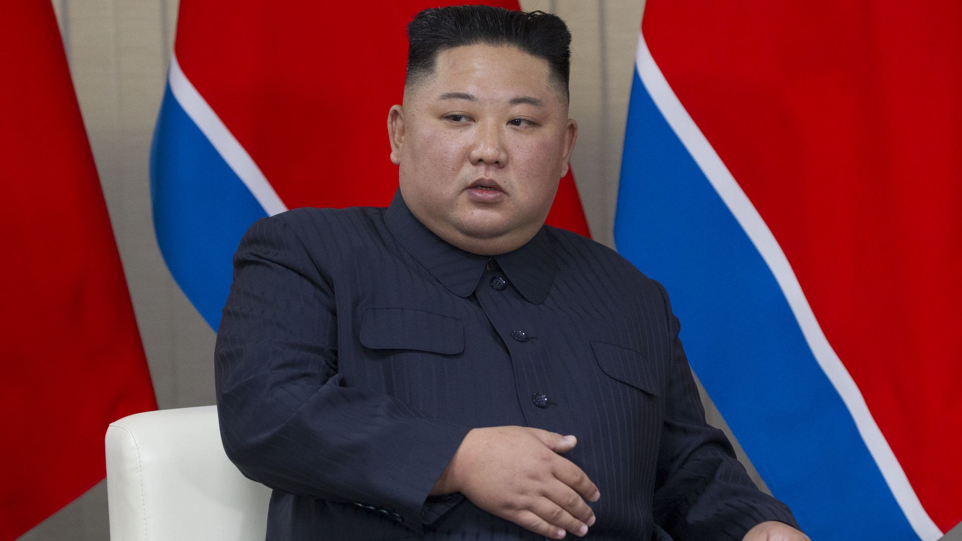 Kim Jong-un sits.