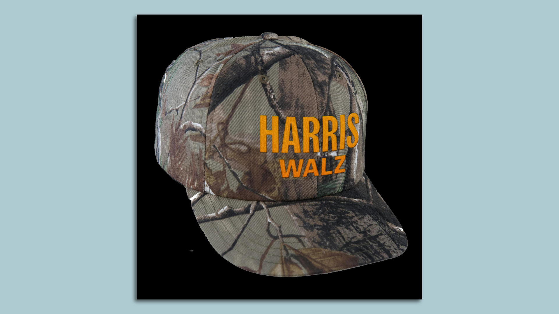 An image of a camouflage hat reading "Harris Walz" in orange letters. 
