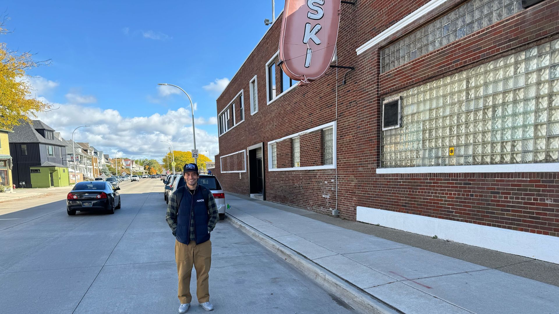 Joe standing next to a mystery brick building