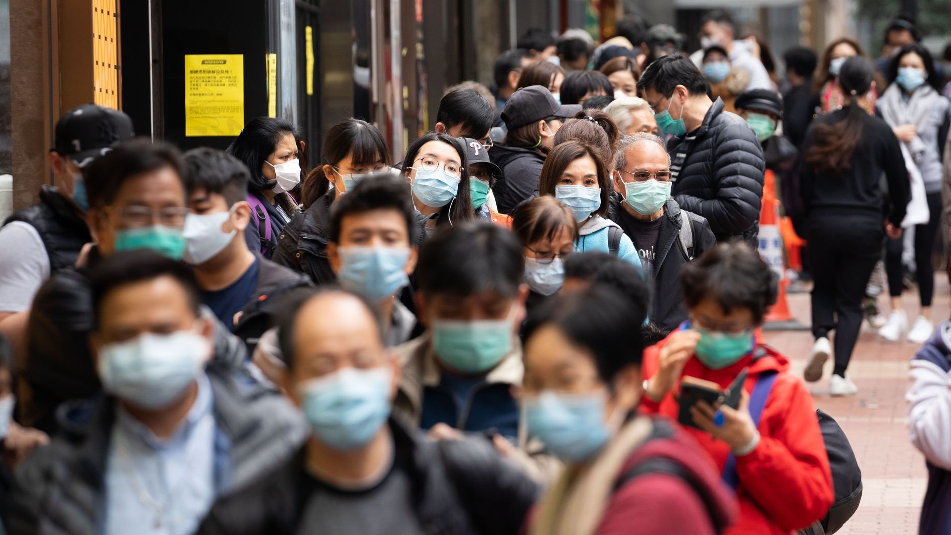 People in the streets in surgical masks.