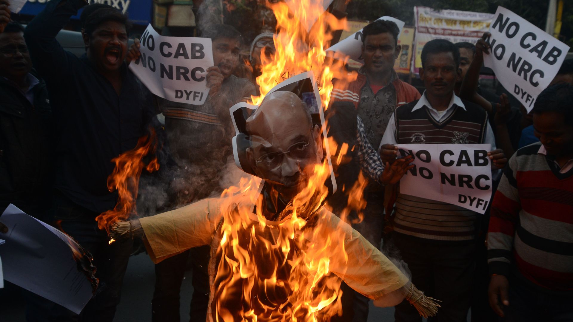 Activists burn an effigy of India's Home Minister Amit Shah during a demonstration against the Indian government's Citizenship Amendment Bill in Siliguri on December 14