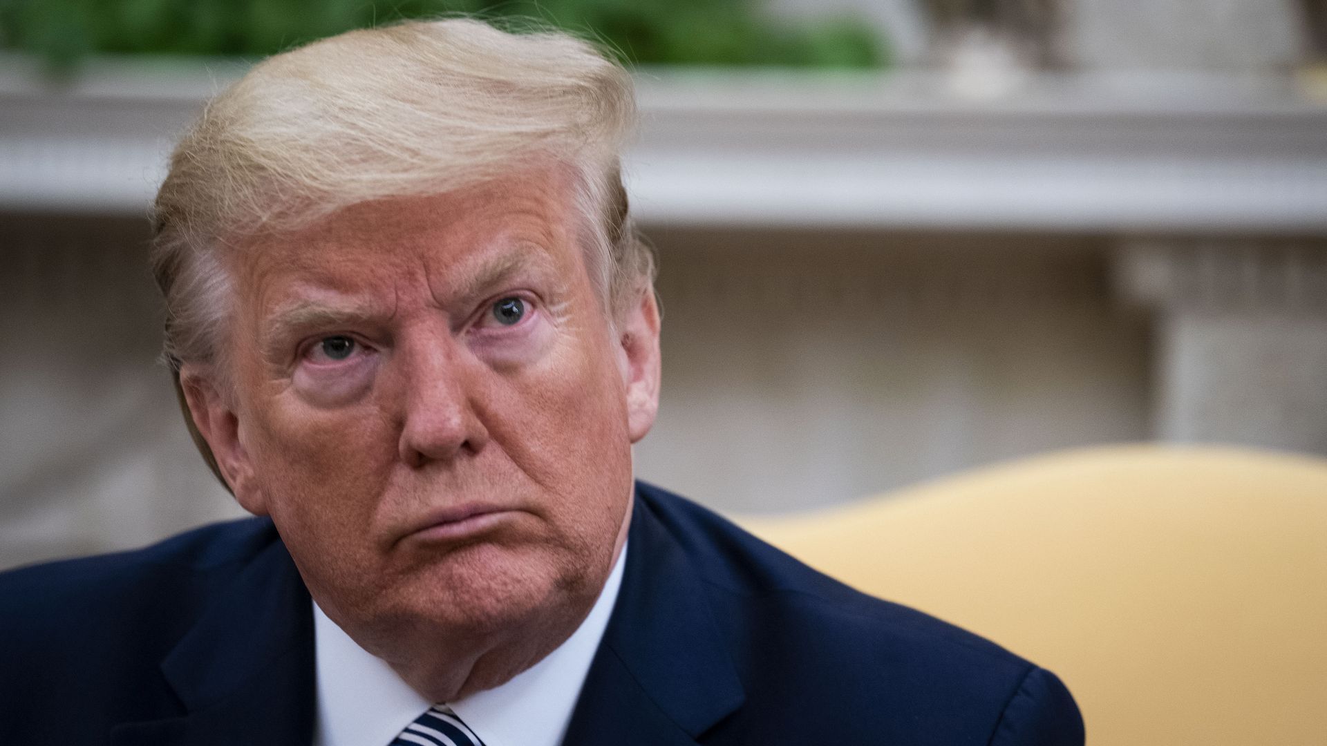 President Donald Trump answers questions while meeting with Florida Gov. Ron DeSantis in the Oval Office