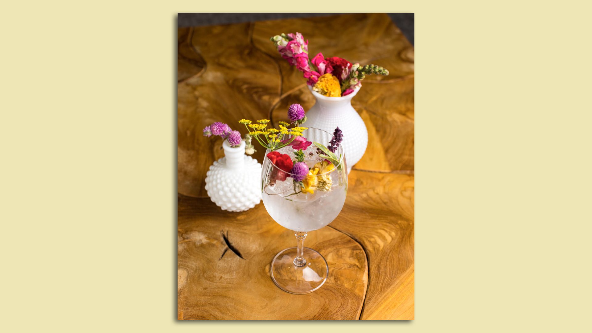 very fancy cocktail with flowers in the drink