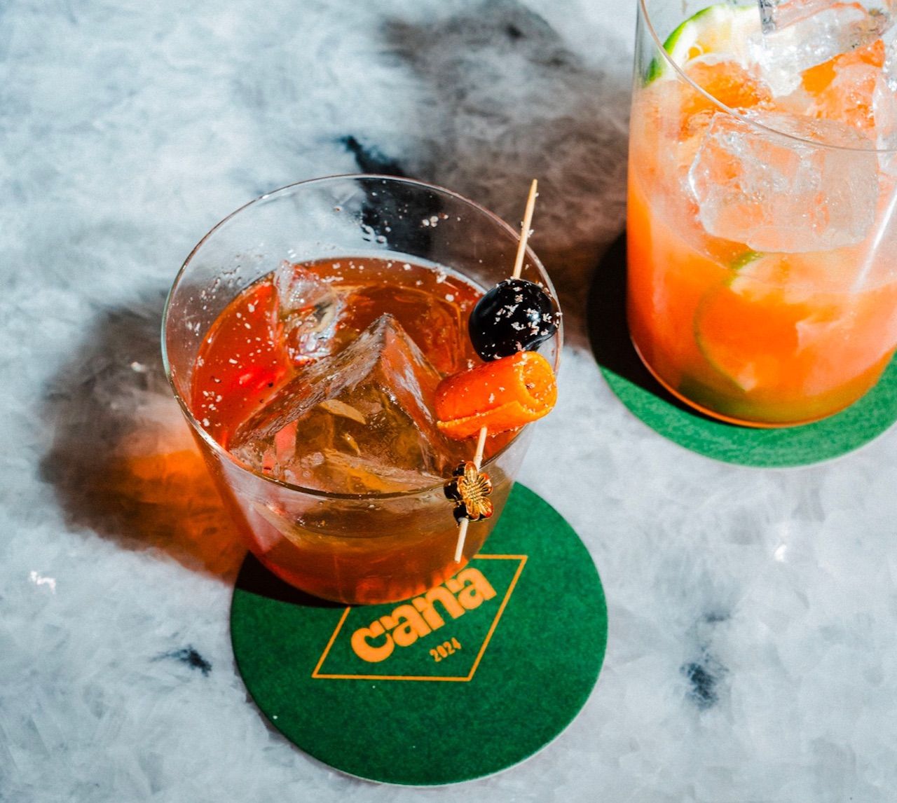 Two cocktails on green coasters