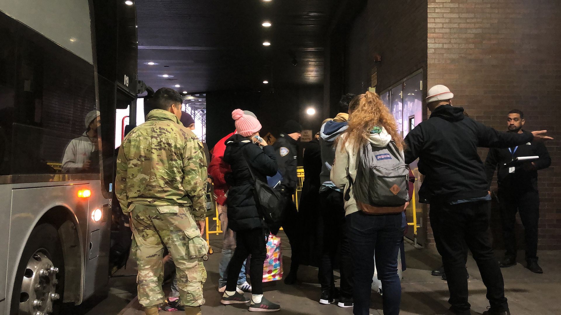 Migrants arriving from Del Rio, Texas, get off a bus at Port Authority in Manhattan