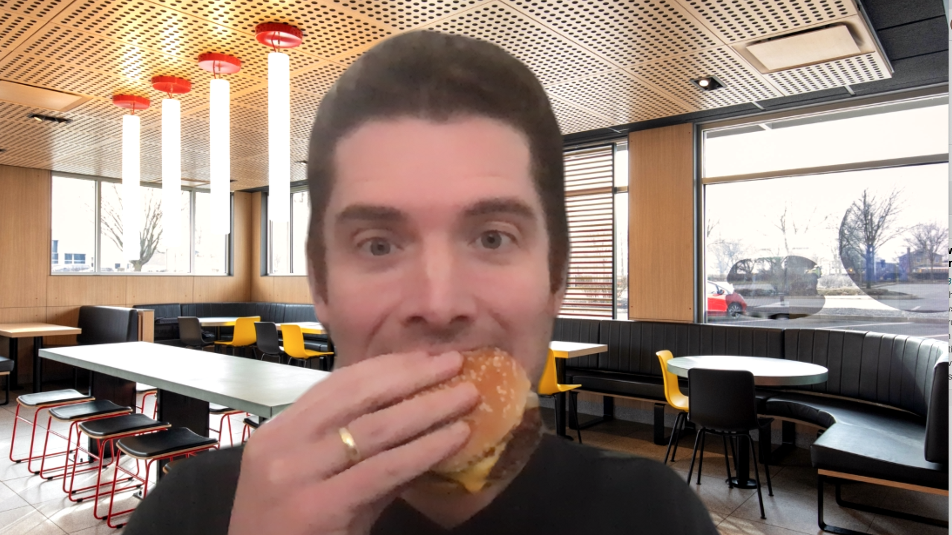 Image of the author eating a cheeseburger in front of a virtual McDonalds