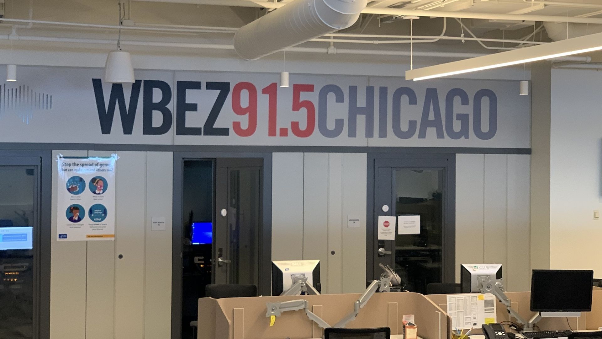 Photo of a sign in a newsroom that says WBEZ91.5CHICAGO