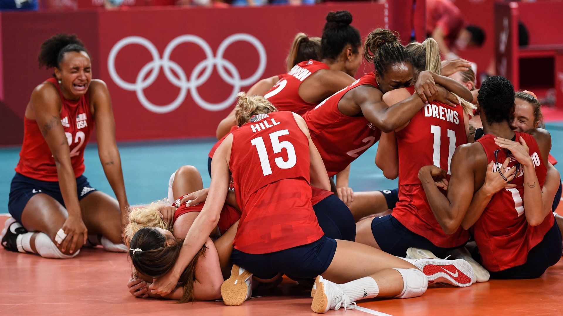 USA's players celebrate their victory in the women's gold medal volleyball match between Brazil and USA during the Tokyo 2020 Olympic Games at Ariake Arena in Tokyo on August 8