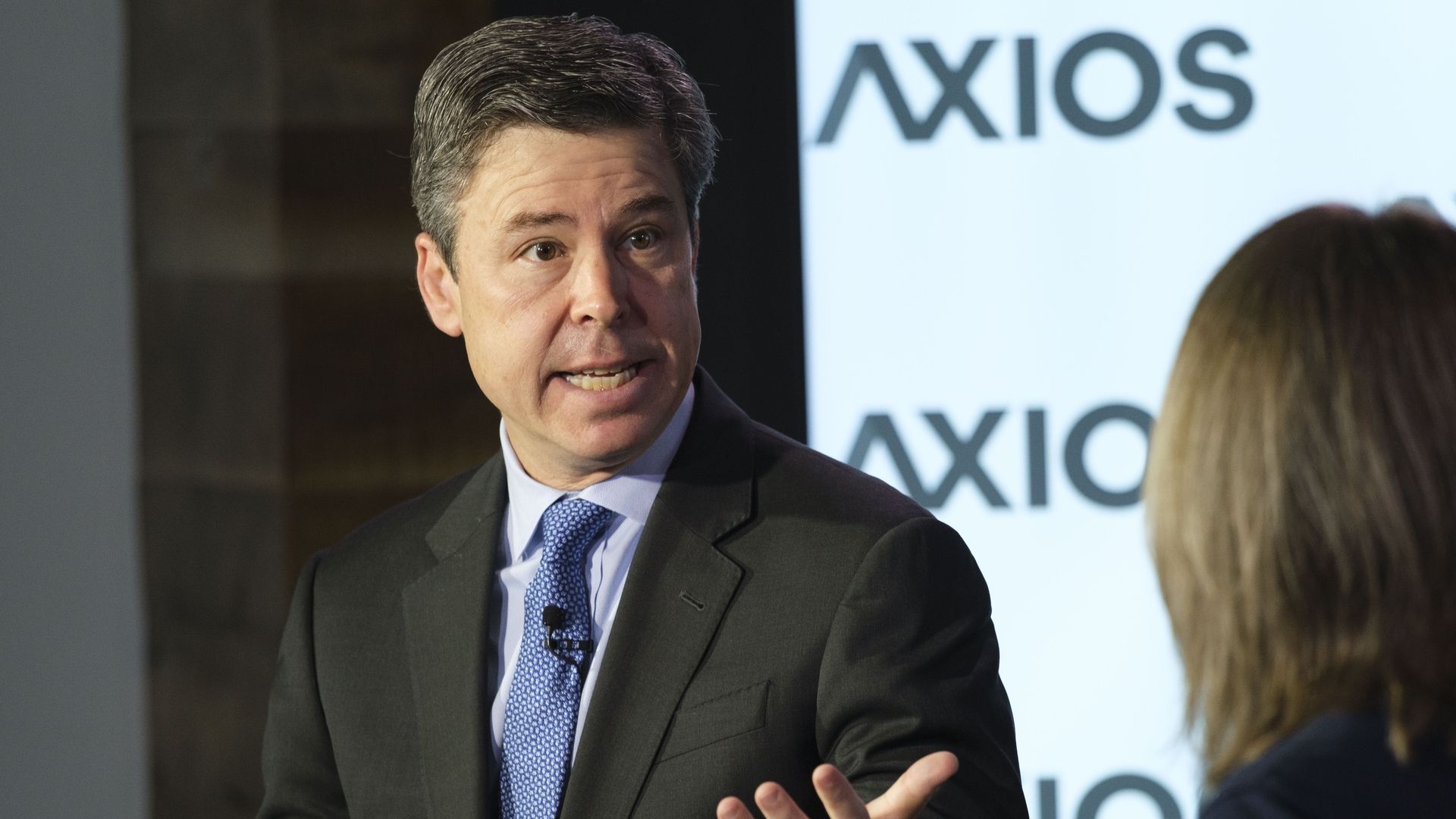 A man speaks in a suit