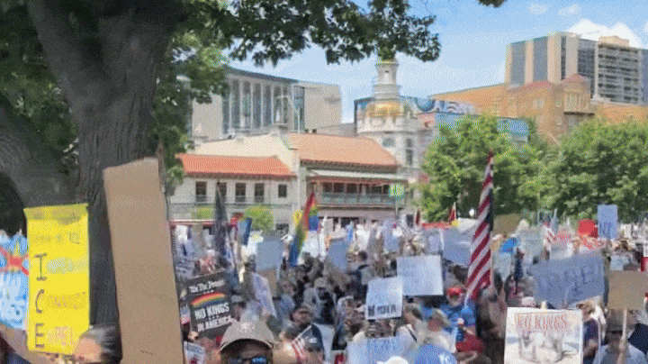 Video panning over a crowd of people protesting in Kansas City
