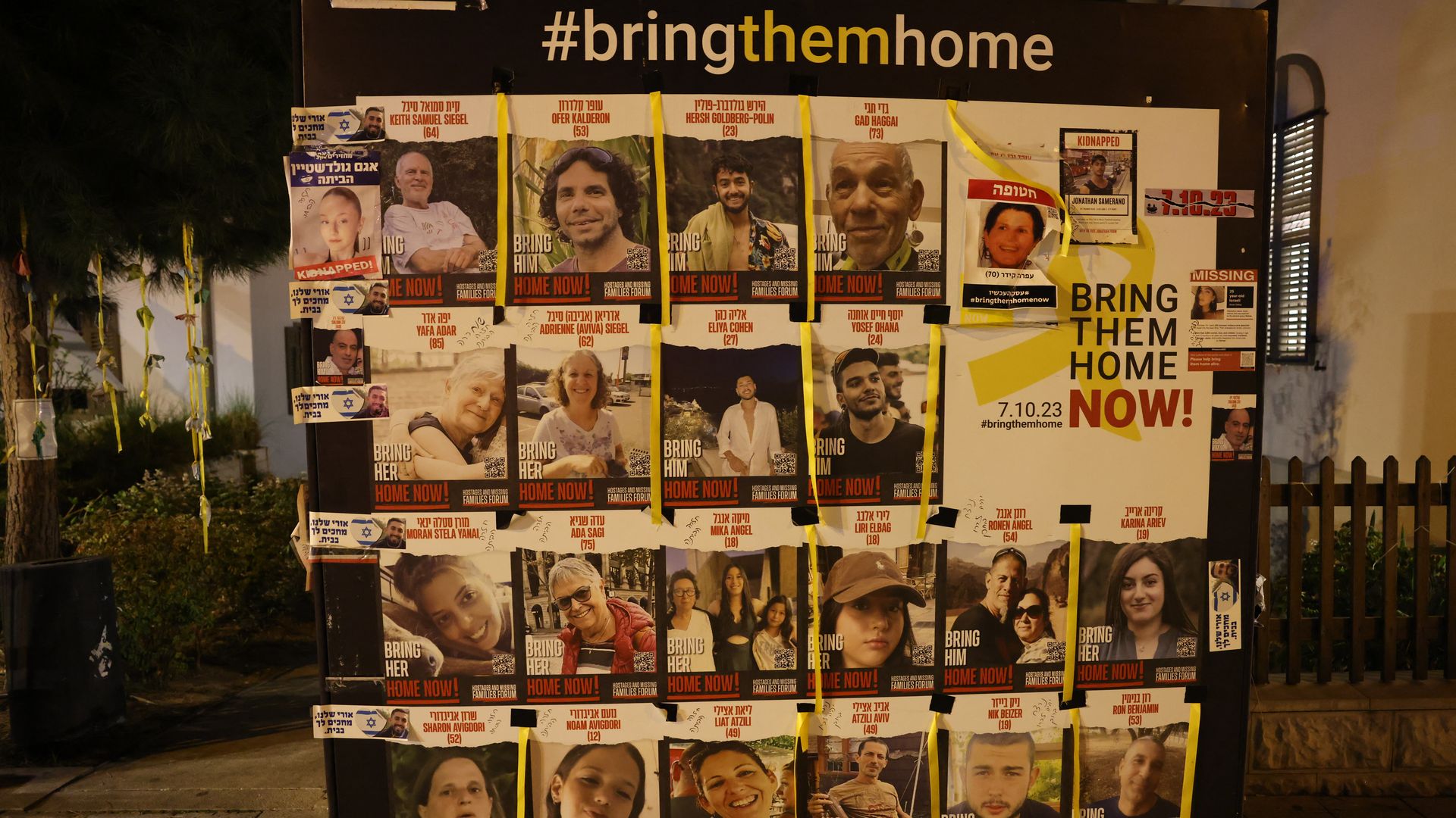 Pictures of some of the Israeli hostages held in Gaza since the October 7 attacks are plastered on a street board in Tel Aviv during a protest calling for their release on February 10, 2024