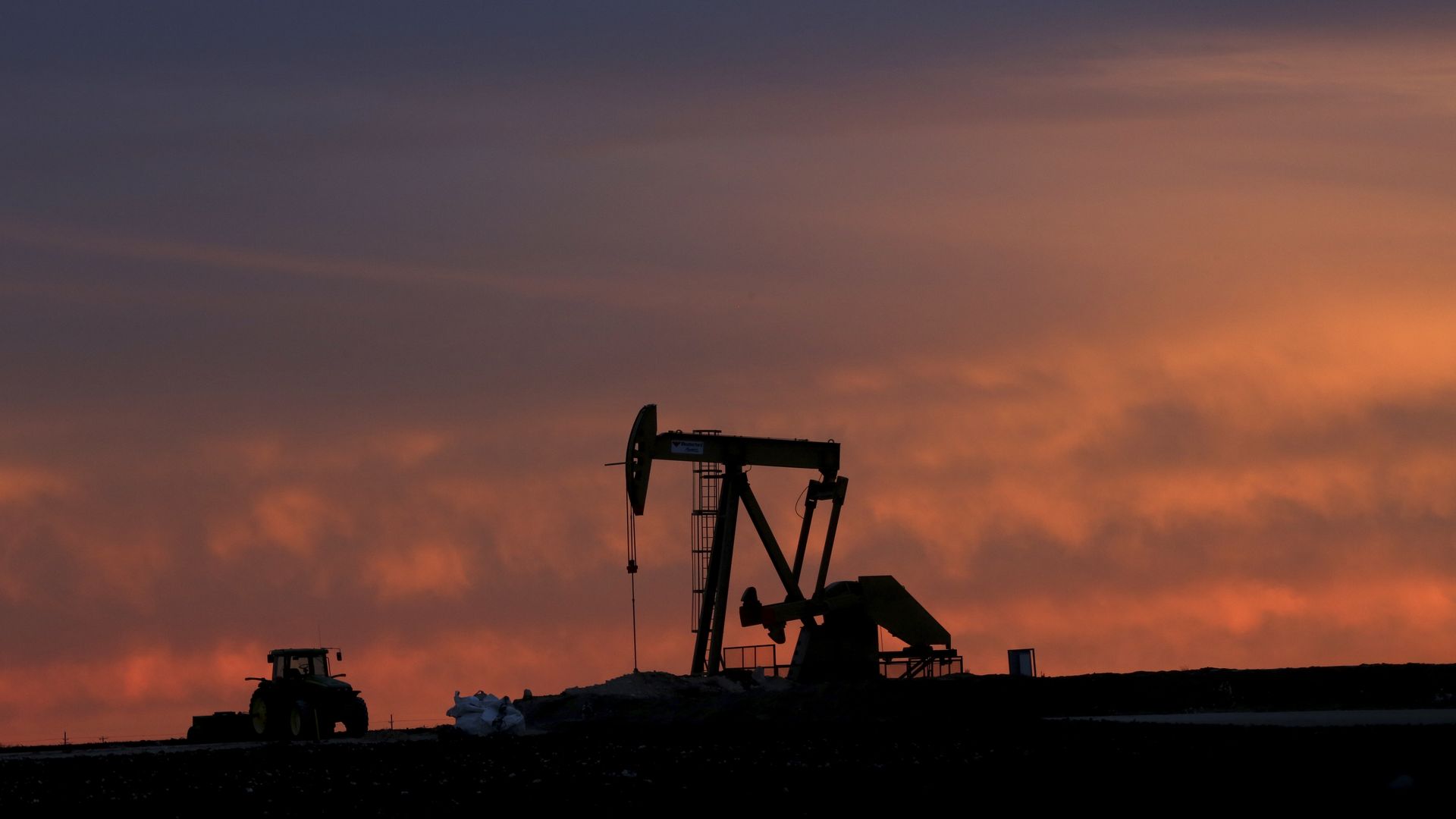 A shale oil pump at sunset