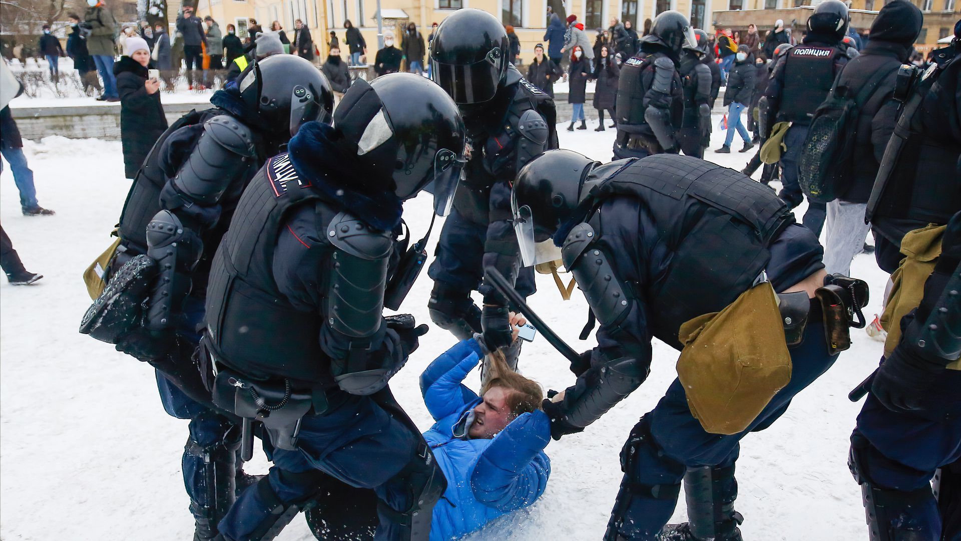 Police officers detain a protester during a demonstration in St. Petersburg Sunday. Demonstrators rallied despite police arresting thousands of protesters last week.
