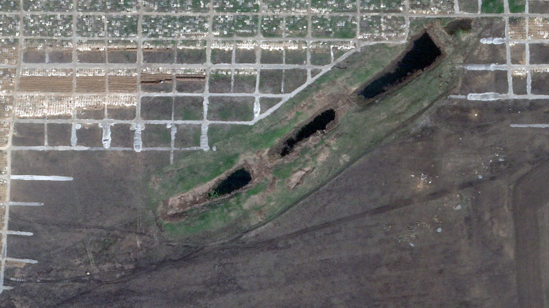 In this satellite image, a mass gravesite can be seen outside a village near Mariupol, which Russia has been bombarding for weeks.