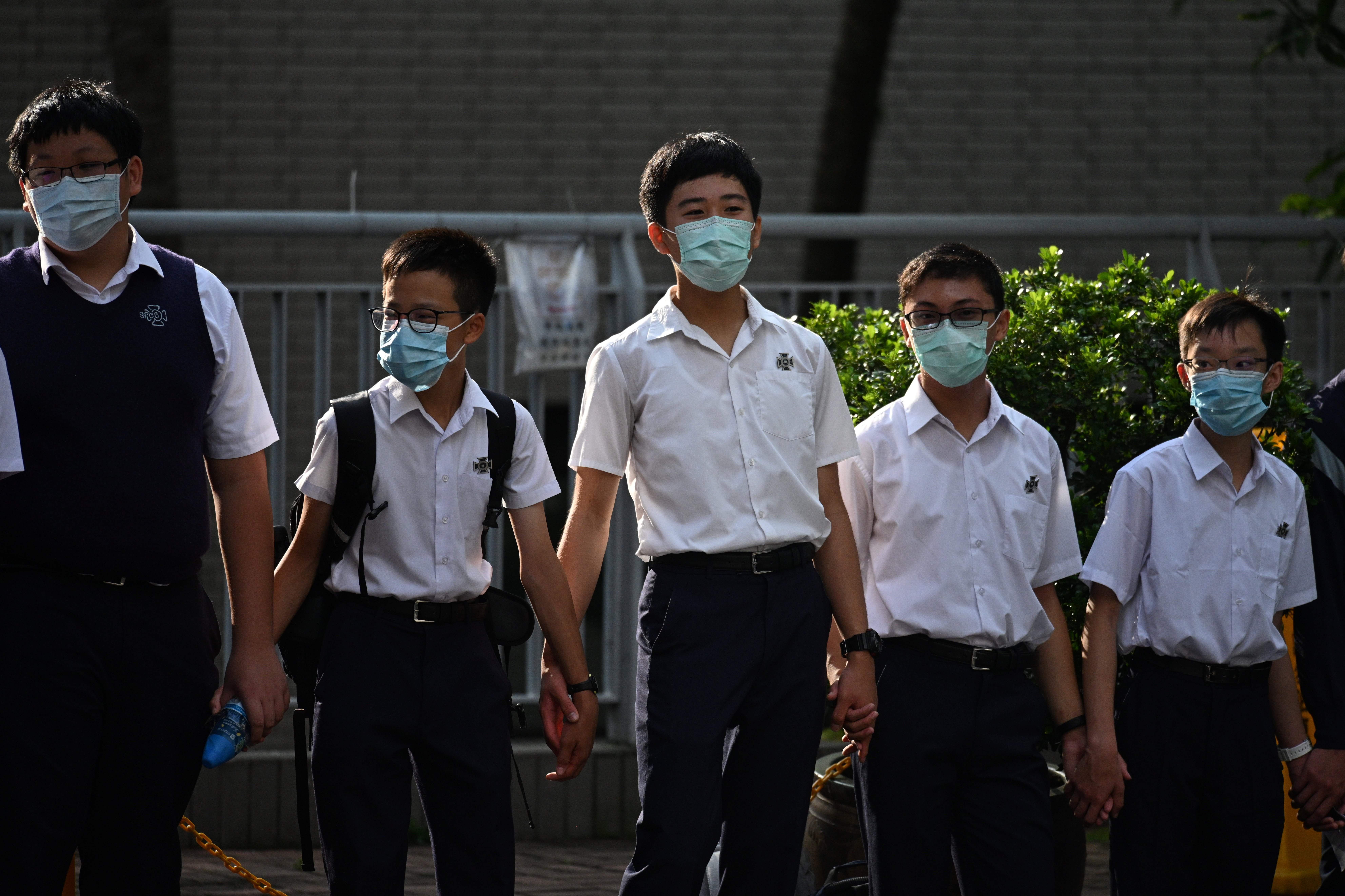 Students in the Mid-Levels area take part in a joint school human chain rally in Hong Kong early on September 9