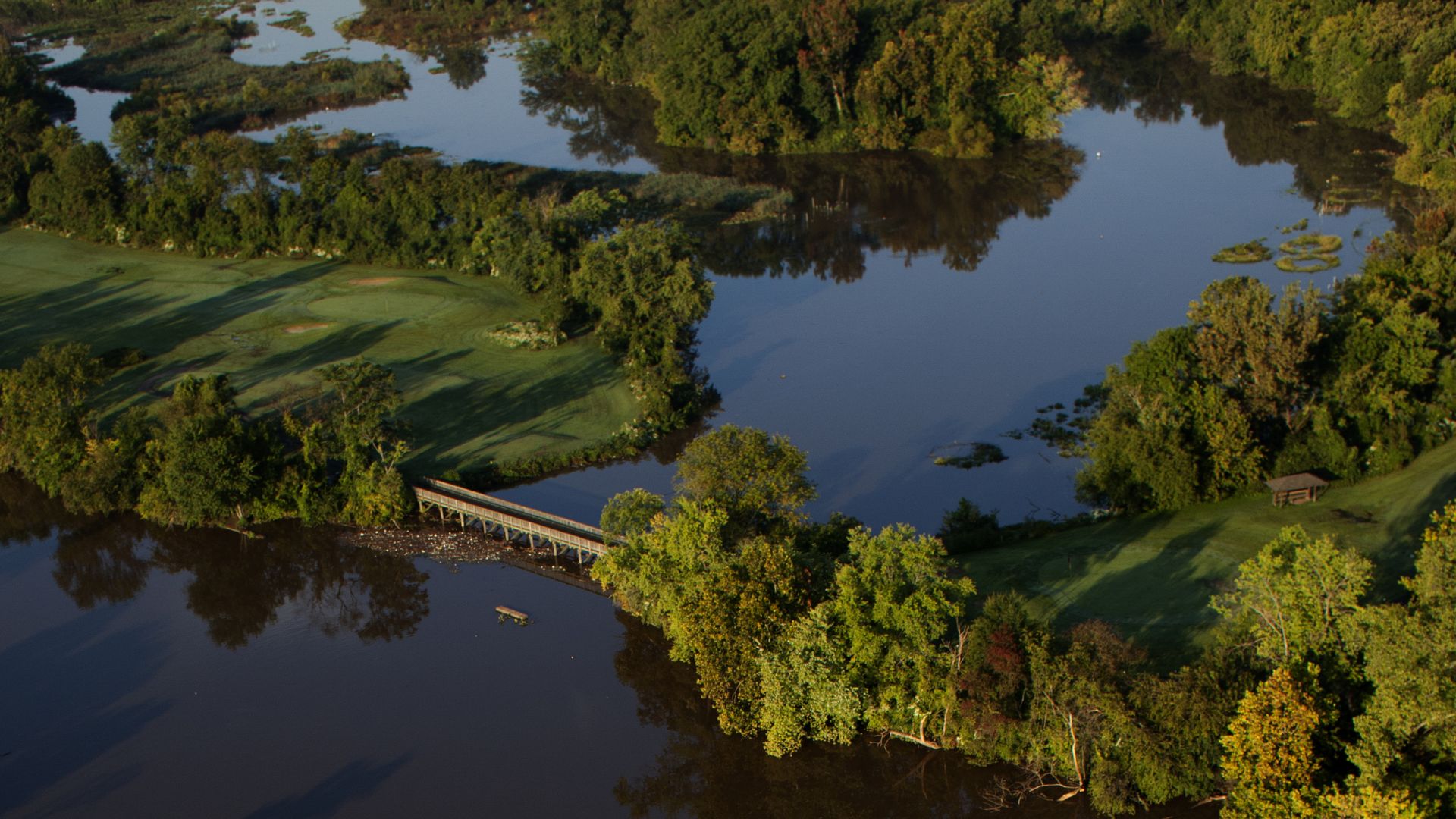A birds-eye photograph of Langston golf course, with the Anacostia River and small islands visible