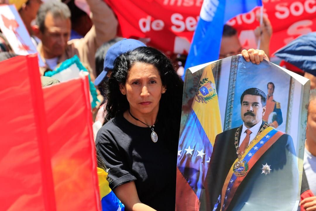 Venezuelan President Nicolas Maduro's supporters gather holding banners and flags during a demonstration in support of Nicolas Maduro, in Caracas, Venezuela.